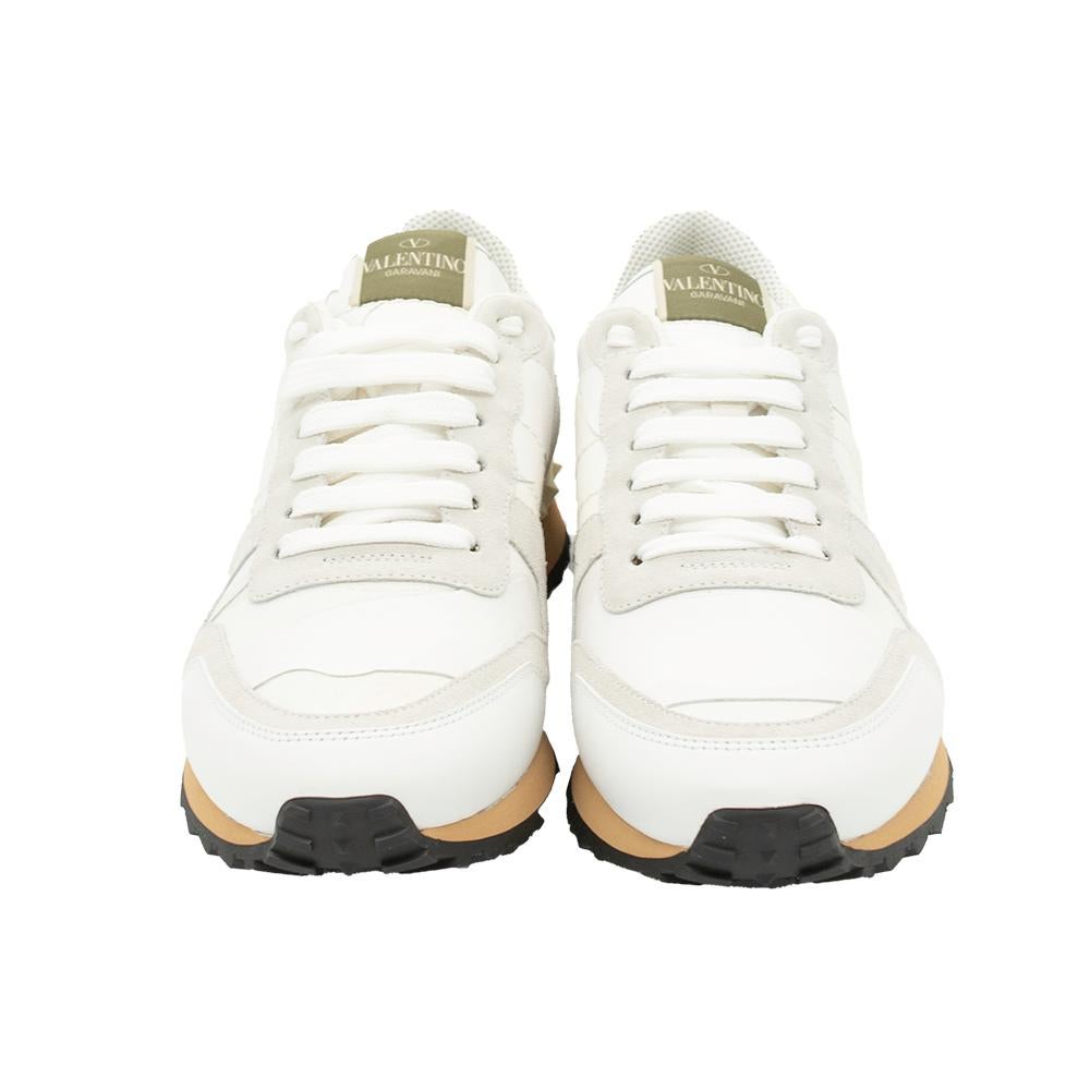 These white-hued Rockrunner sneakers from Valentino are made for the ones who want to stand out. Crafted from fine suede and leather, these come in a camouflage design and lace-ups on the vamps. They have Rockstud detailing on the counters and tough