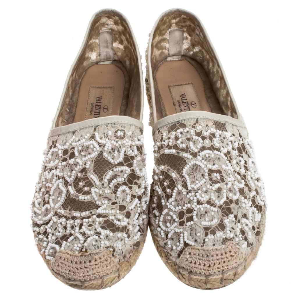 Step out in style every day with these gorgeous espadrilles from Valentino. Featuring a pretty lace exterior, this round-toe pair is completed with embellished details and knitted details on the cap toes. Slip these on with shorts and