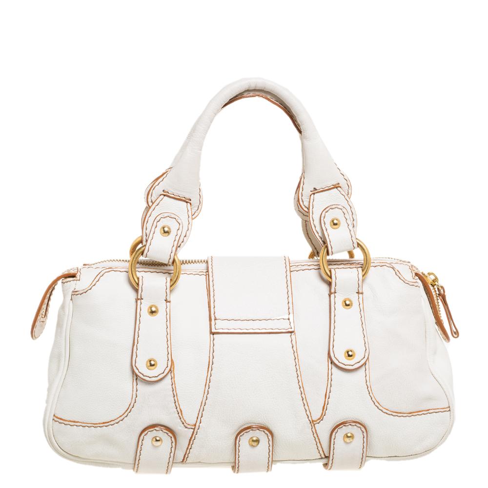 This white satchel from Valentino radiates a charm that will amaze the crowds wherever you go! The bag is crafted from leather and features an artistic silhouette. It flaunts dual top handles, front flap closure with a crystal embellished brand logo