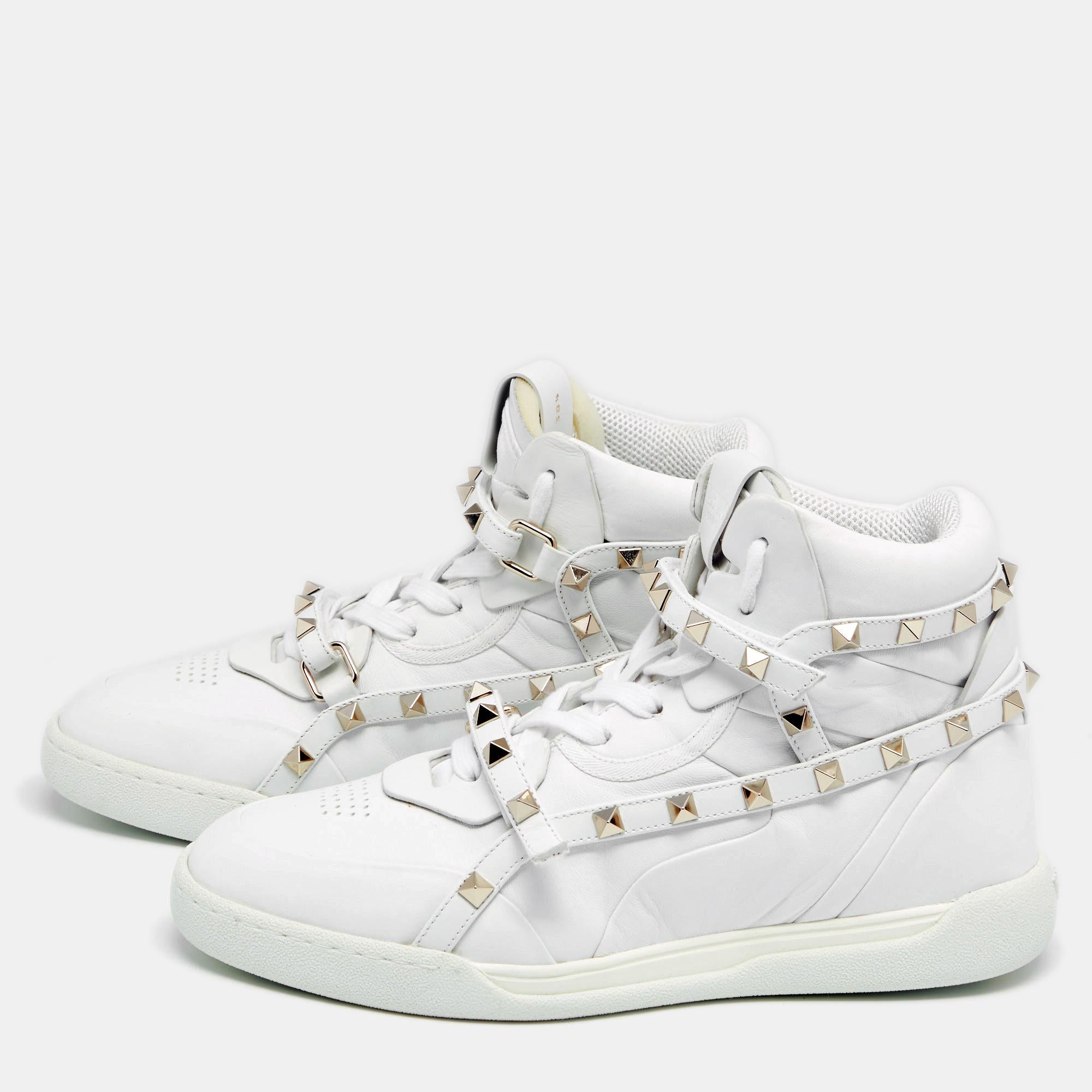 With durable rubber soles and recognizable Rockstuds, these Valentino sneakers are worth the investment. The leather creation flaunts lace-up vamps, buckle design, and branded tongue. The white shade of this high-top pair makes it