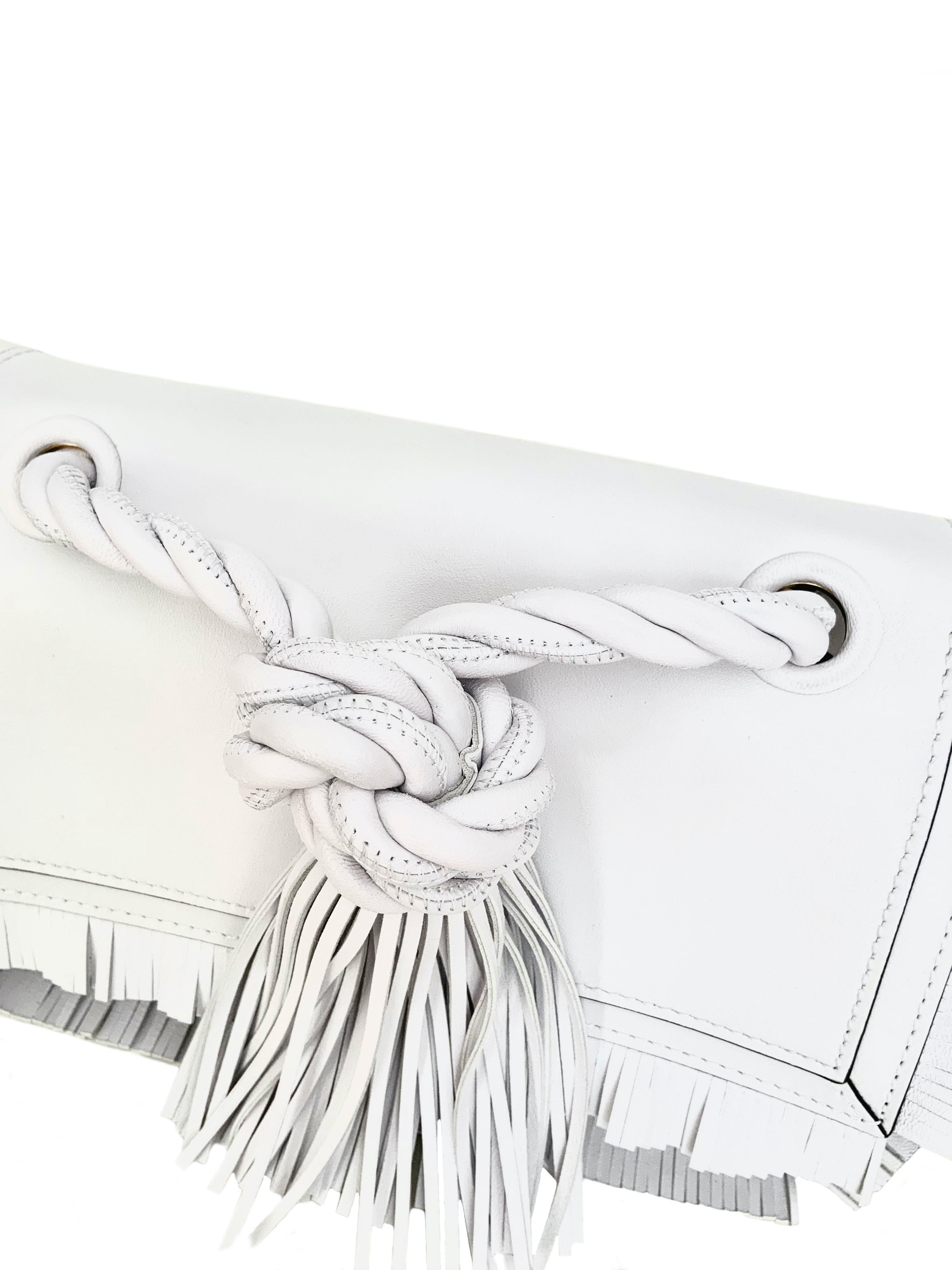 Decorated with subtle fringing edges and a rope top handle with tassle, this pre-owned but new bag from the house of Valentino Garavani is crafted in smooth lambskin with a well-lined suede interior.
Removable shoulder strap.

Collection: