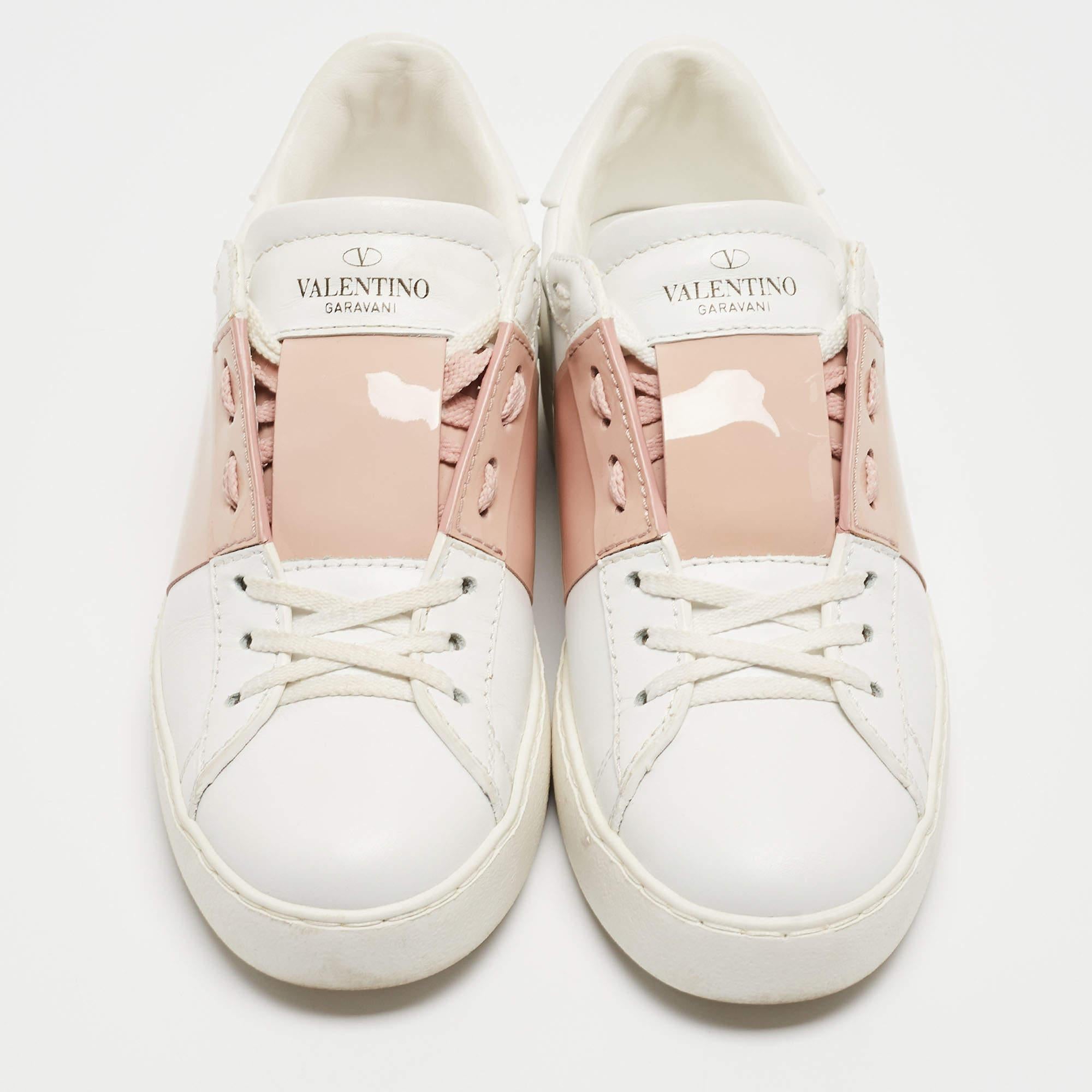 These Valentino leather sneakers are trendy yet casual with their showy gold band of leather on the quarter panel. Signature Valentino rubber rockstuds are present on the rear midsole, below the foldback collar. The slip-on style, rubber soles and