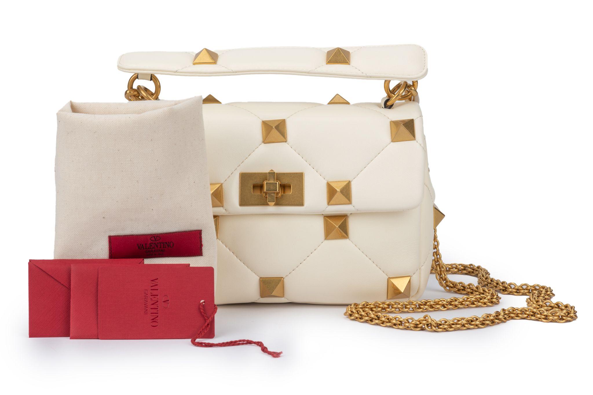 Valentino Garavani Roman Stud The Shoulder Bag in lambskin nappa with chain. Quilted construction, embellished with maxi studs. Equipped with both a detachable sliding chain strap (25”) and a detachable handle.(3”) The bag is new and comes with the