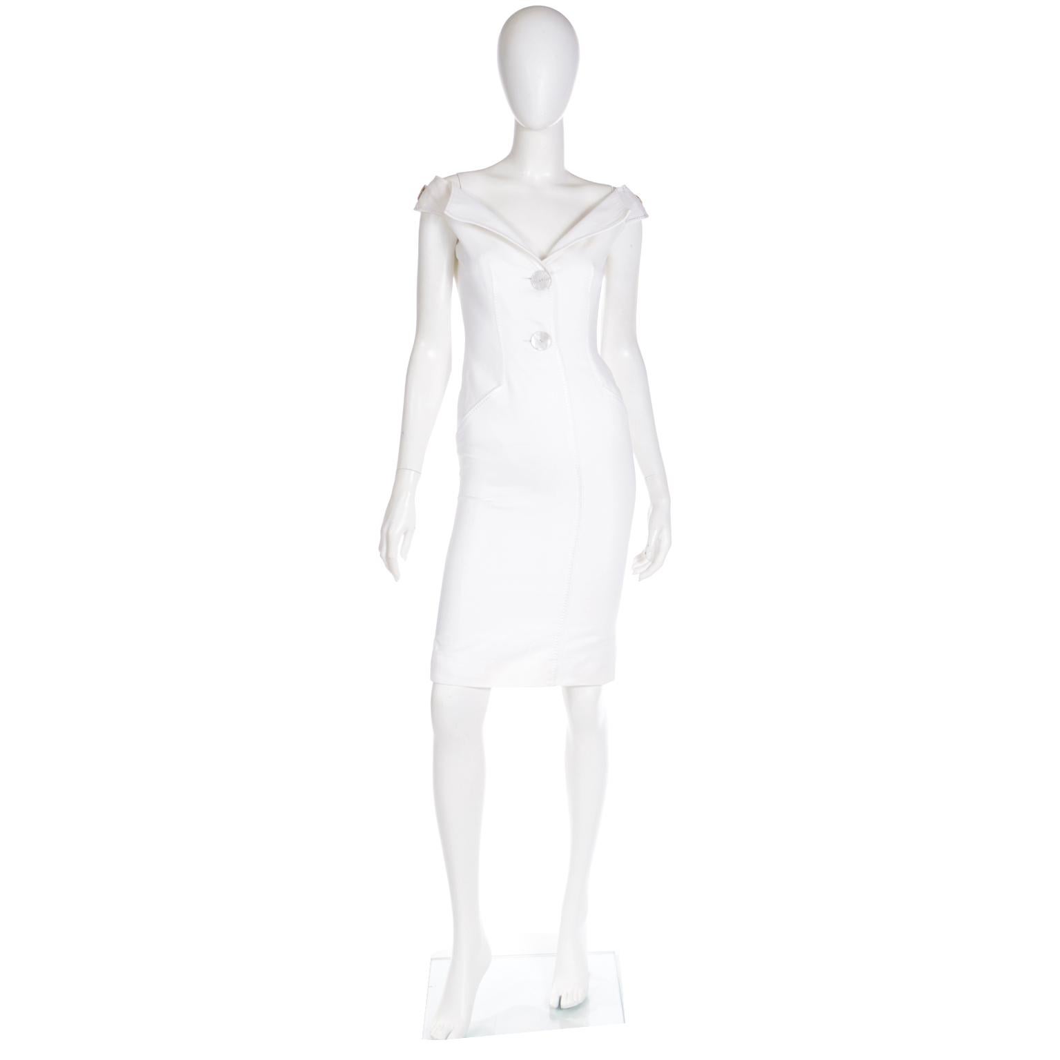 This is a really lovely Valentino ivory sheath dress with huge mother of pearl buttons	on the front of the bodice and at the top of the shoulders. This beautifully made dress is in a pretty finely ribbed cotton and it is fully lined. We love the