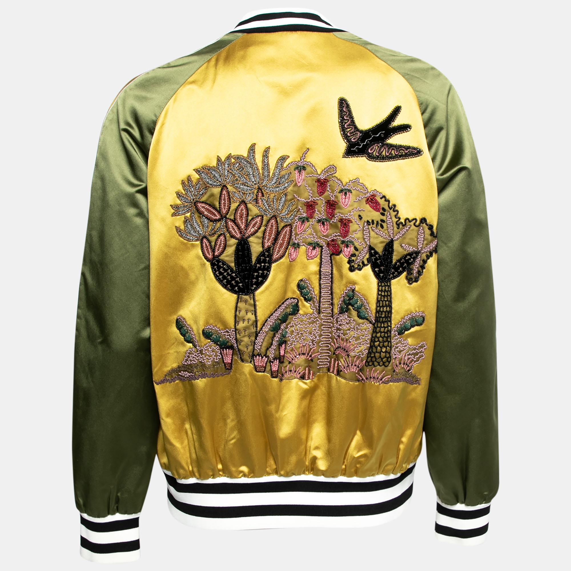 This Bomber jacket from the House of Valentino will help you sport a dapper style. It is designed using yellow-green silk satin fabric, which is augmented with embroidered patches. It has long sleeves, a zipper fastening, and two pockets. This