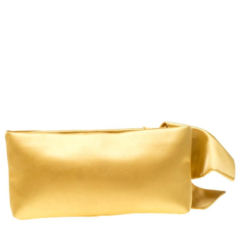 This clutch by Valentino is what you would carry on an evening out. The yellow satin exterior is gorgeously detailed with a lovely oversized bow and a top zip closure. The satin interior will easily hold your little essentials.

Includes: Original