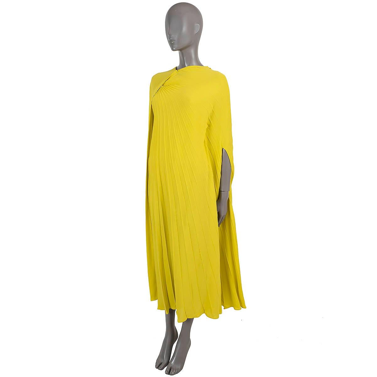 100% authentic Valentino pleated midi dress in chartreuse yellow crepe silk (100%). Features a cape-effect overlay that falls over the shoulders and flows beautifully as you walk. Opens with a concealed zipper in the back and comes with a nude body