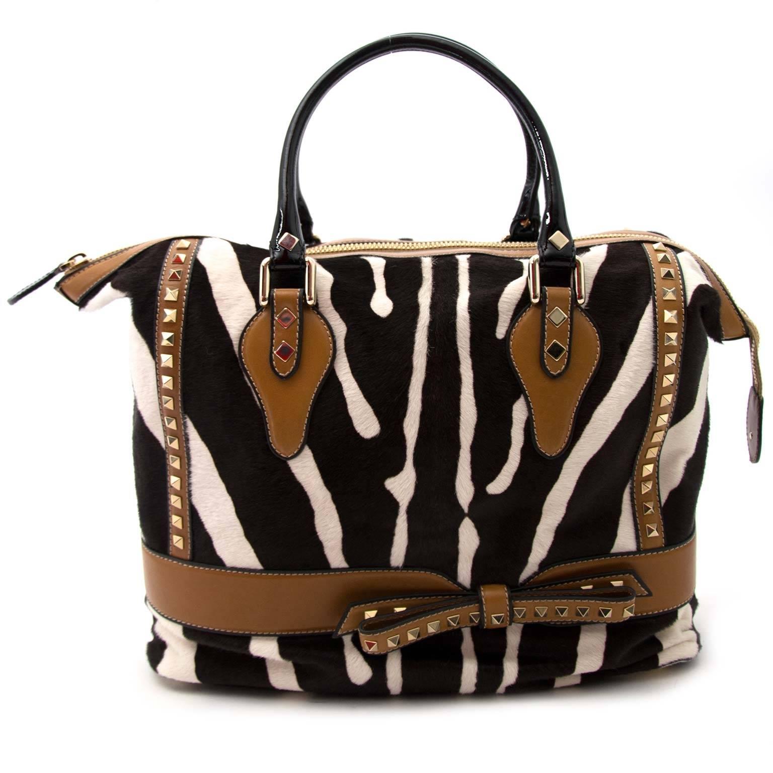 Excellent Condition!

Valentino Zebra Motive Pony Hair Leather Studded Bag

Let this bag bring out the animal in you! The zebra print in pony hair gives this bag its spectacular look and feel, and will definitely make heads turn when you're walking