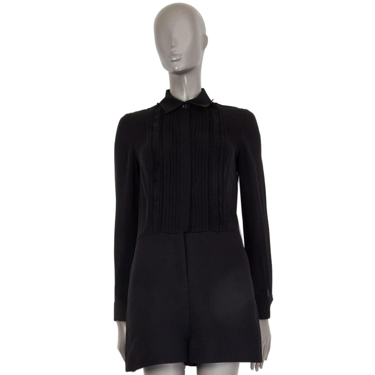 authentic Valentino long-sleeve romper with a ruched shirt top part in black silk (100%). Hot pants are made of black virgin wool (65%) and silk (35%). Opens with buttons and a zipper at front. Has been worn and the hidden buttons have a bit color