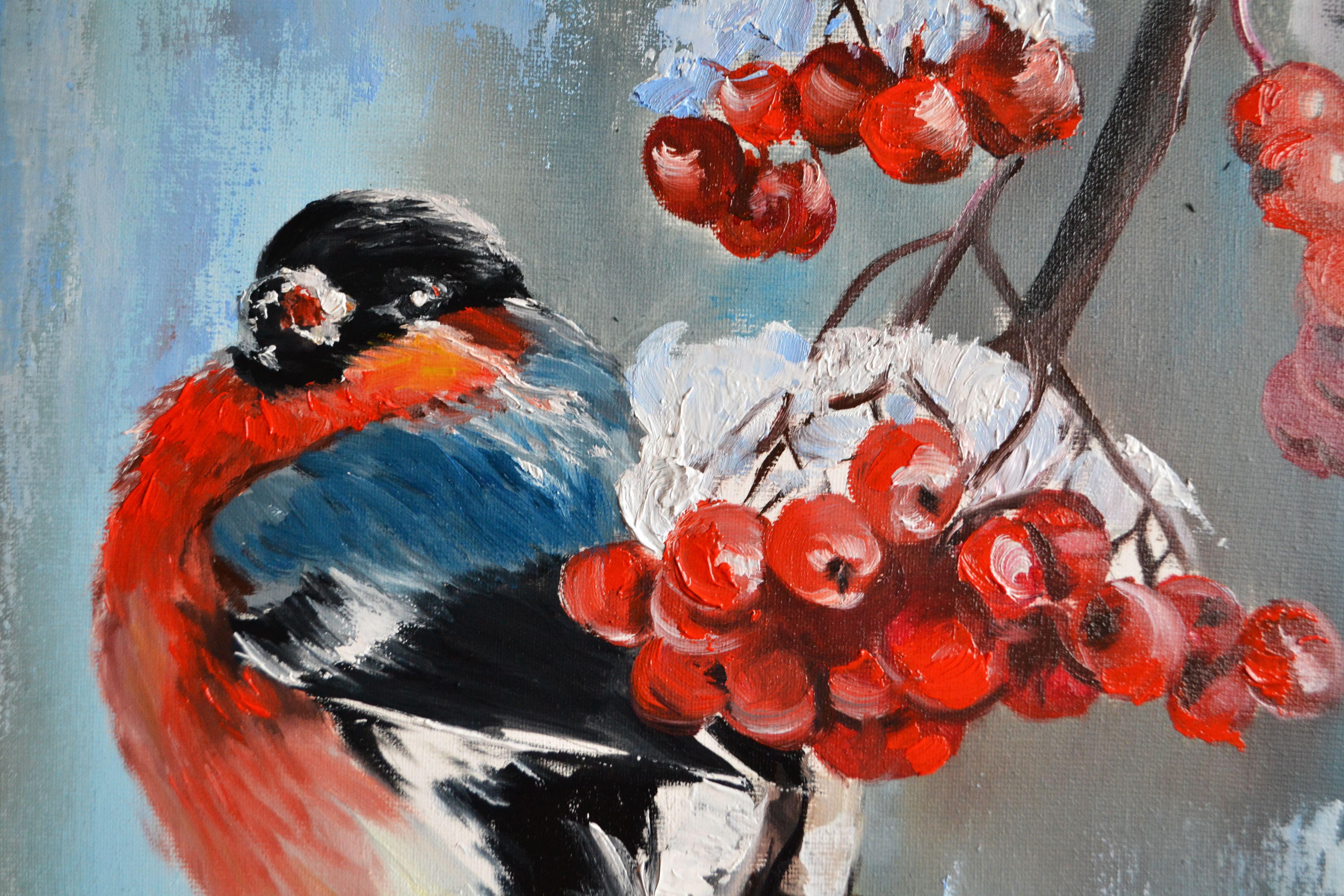 Big red bullfinch on a rowan branch sprinkled with snow. Red, white, blue, purple - the festive colors of winter. The red bird looks like a big red heart. It will be a wonderful bright accent in your home, as well as a wonderful gift and symbol of