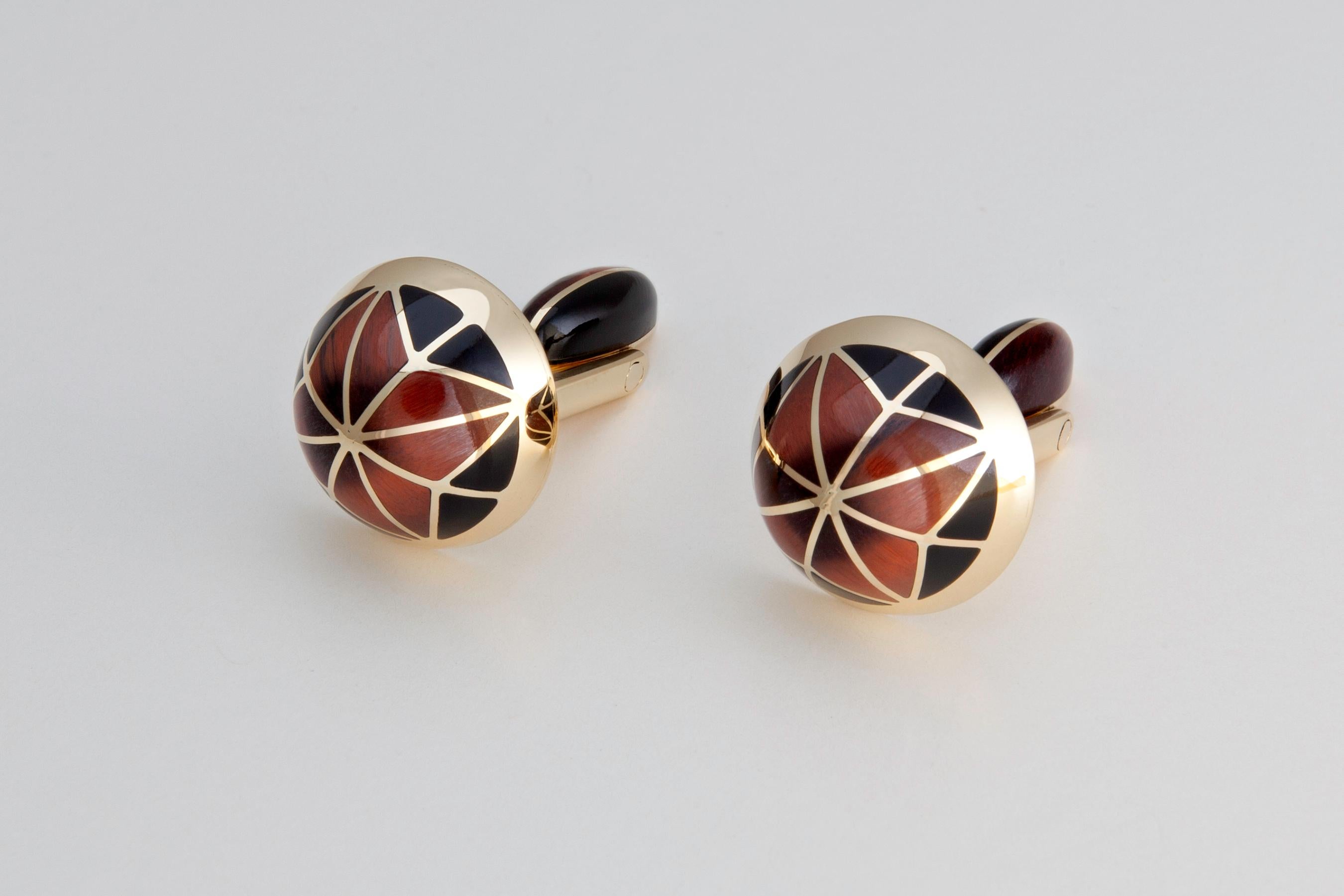  'The Cynosure' cufflinks; fabricated by hand in  18K Yellow Gold, inlaid with Wyoming Black Jade and Australian Tiger Iron, embody the very essence of the word.  By definition, the Cynosure is;  the brightest star in the sky, something serving for