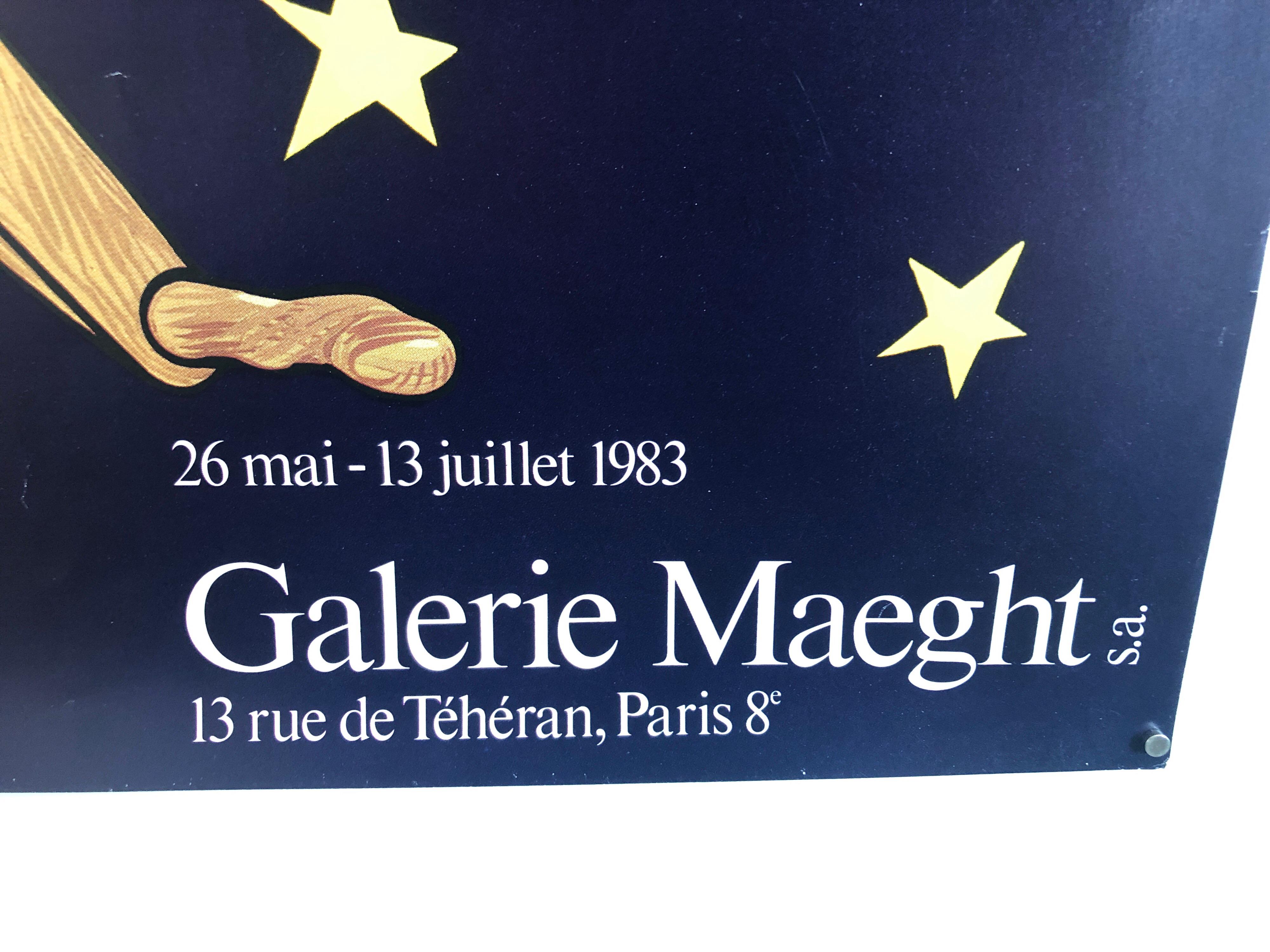 Vintage gallery exhibition poster. Navy blue and bold yellow stars with vibrant orange. Surrealist man in hat with scythe or fishing rod.
The Galerie Maeght is a gallery of modern art in Paris, France, and Barcelona, Catalonia, Spain. The gallery