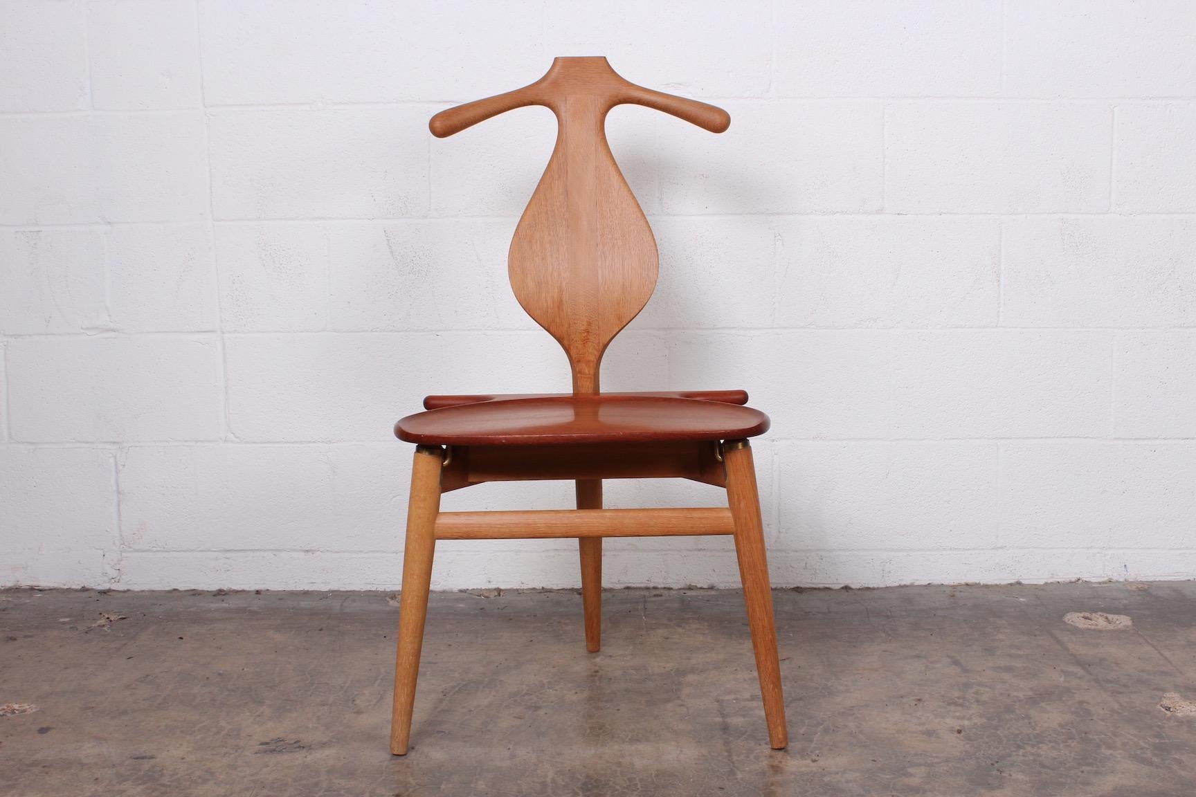 An iconic valet chair in teak and oak. Designed by Hans Wegner for Johannes Hansen.