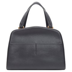 Valextra, borsa a tracolla in pelle nera con doppia tasca frontale e manico superiore in tonalità oro