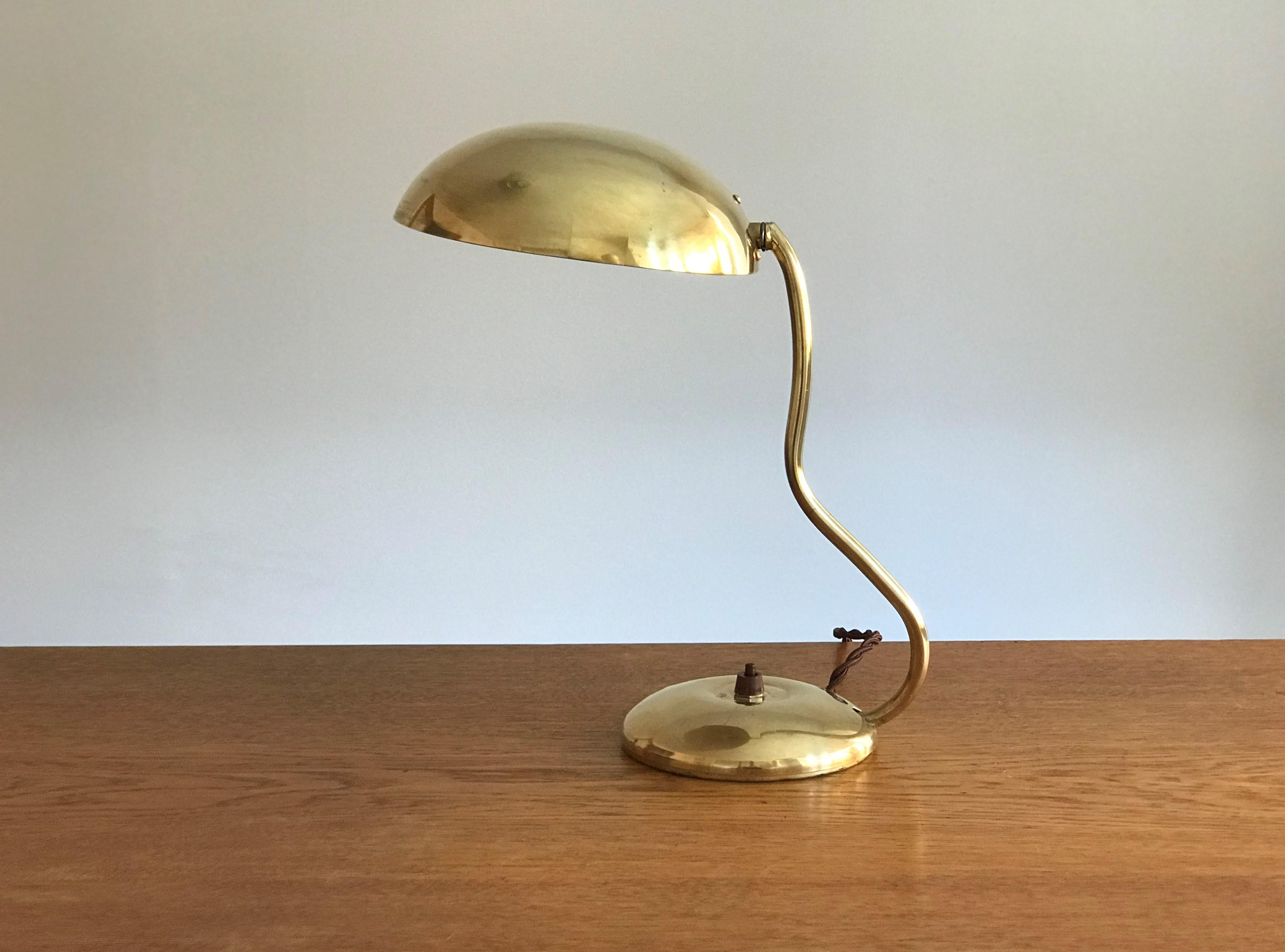 A modernist organic design table lamp. Executed by Valinte OY and marked with producers stamp. Brass on enamel, bakelite, and fabric cord. Positions adjustable. 

Other notable midcentury lighting designers include Paavo Tynell, Alvar Aalto, Max