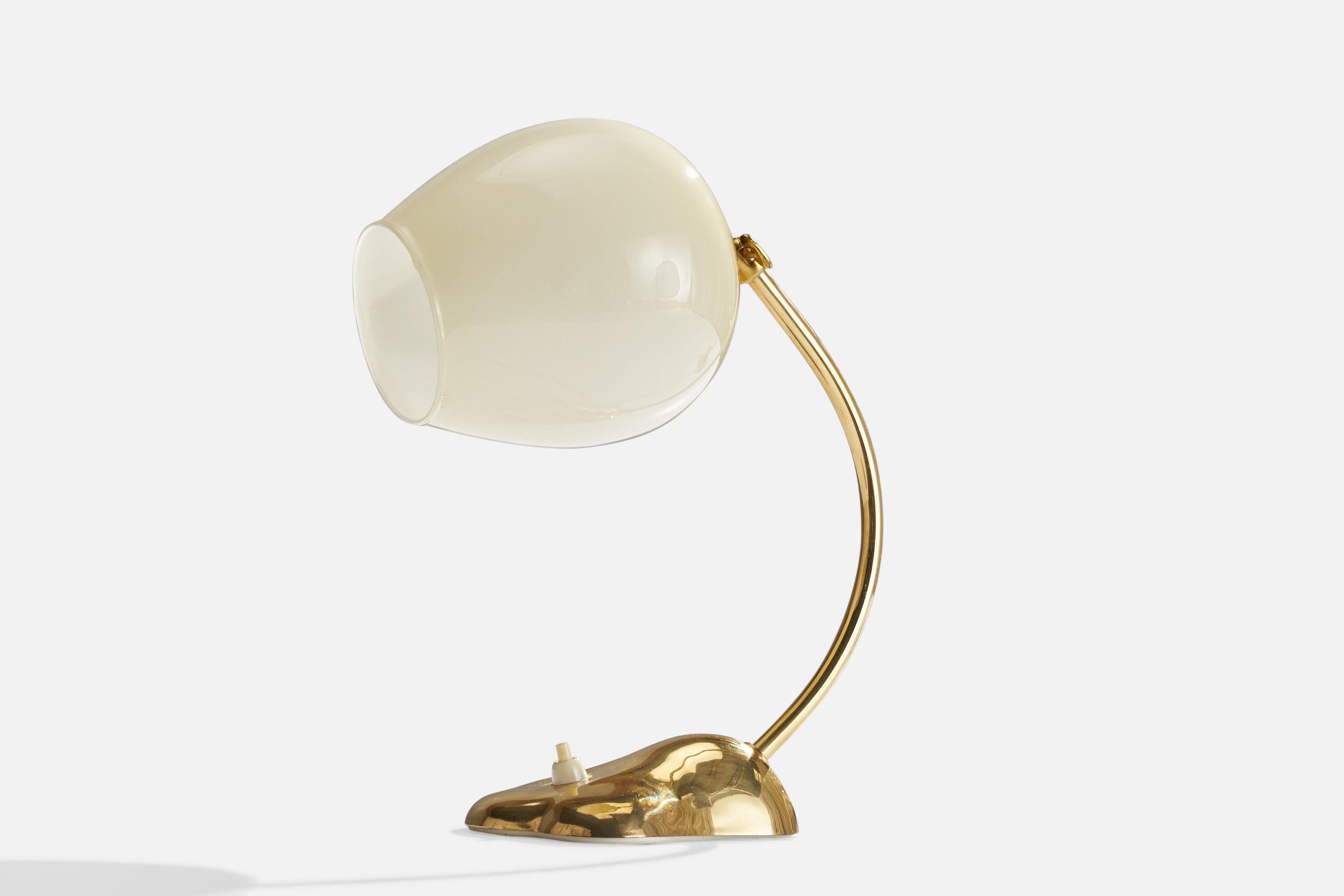 An adjustable brass and opaline glass table lamp designed and produced by Valinte OY, Finland, 1950s.

Overall Dimensions (inches): 11” H x 4.75” W x 9”  D
Stated dimensions include shade.
Bulb Specifications: E-26 Bulb
Number of Sockets: 1
All