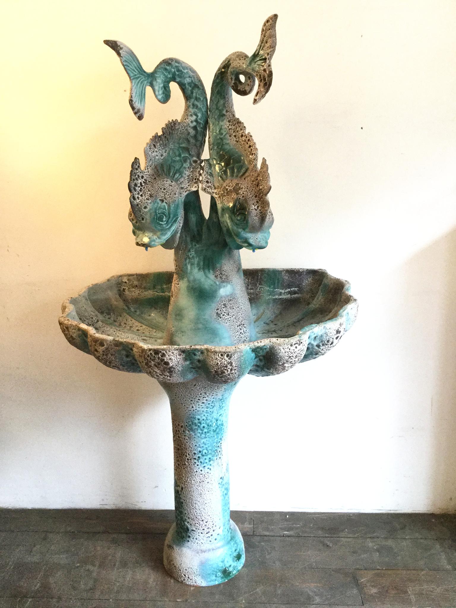 Large 1950s Vallauris ceramic and terracotta fountain in three parts. Water comes out the mouths of the two dolphins in a closed circuit. 
Workshop Auguste Lucchesi Créations Luc.