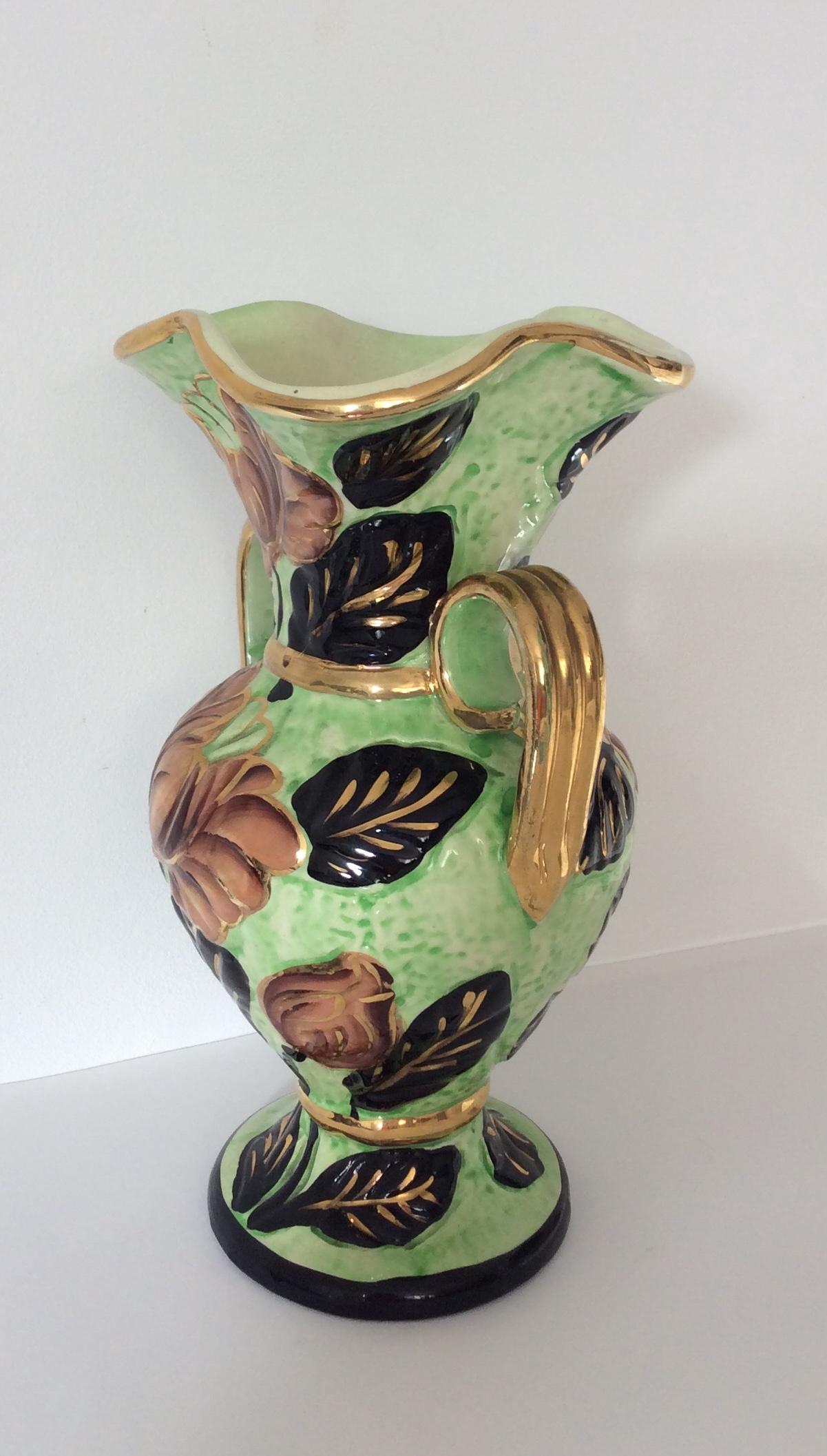 Lovely hand-painted ceramic flower vase from Vallauris, France. 
Signed Vallauris, JH and numbered 503.

Gold trim finish and beautiful floral details makes this hand-painted ceramic flower vase appealing. An eye-catching piece of decorative art.