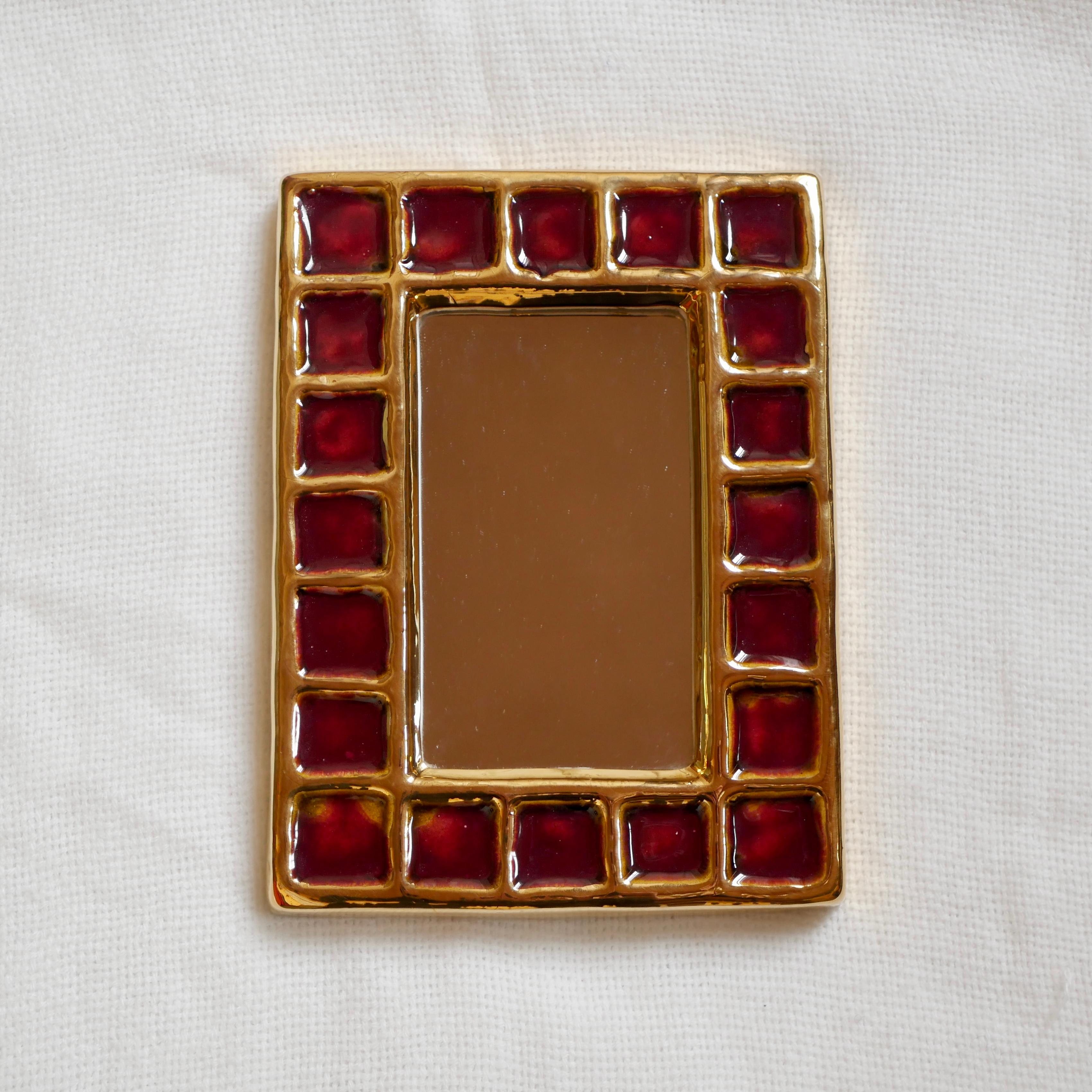 Beautiful jewel-like mirror by François Lembo, made in the 1960s in his Vallauris workshop.
Red and gold squares, excellent condition.
With the iconic signature on the back.

François Lembo was born in Vallauris and started his career in 1951 in