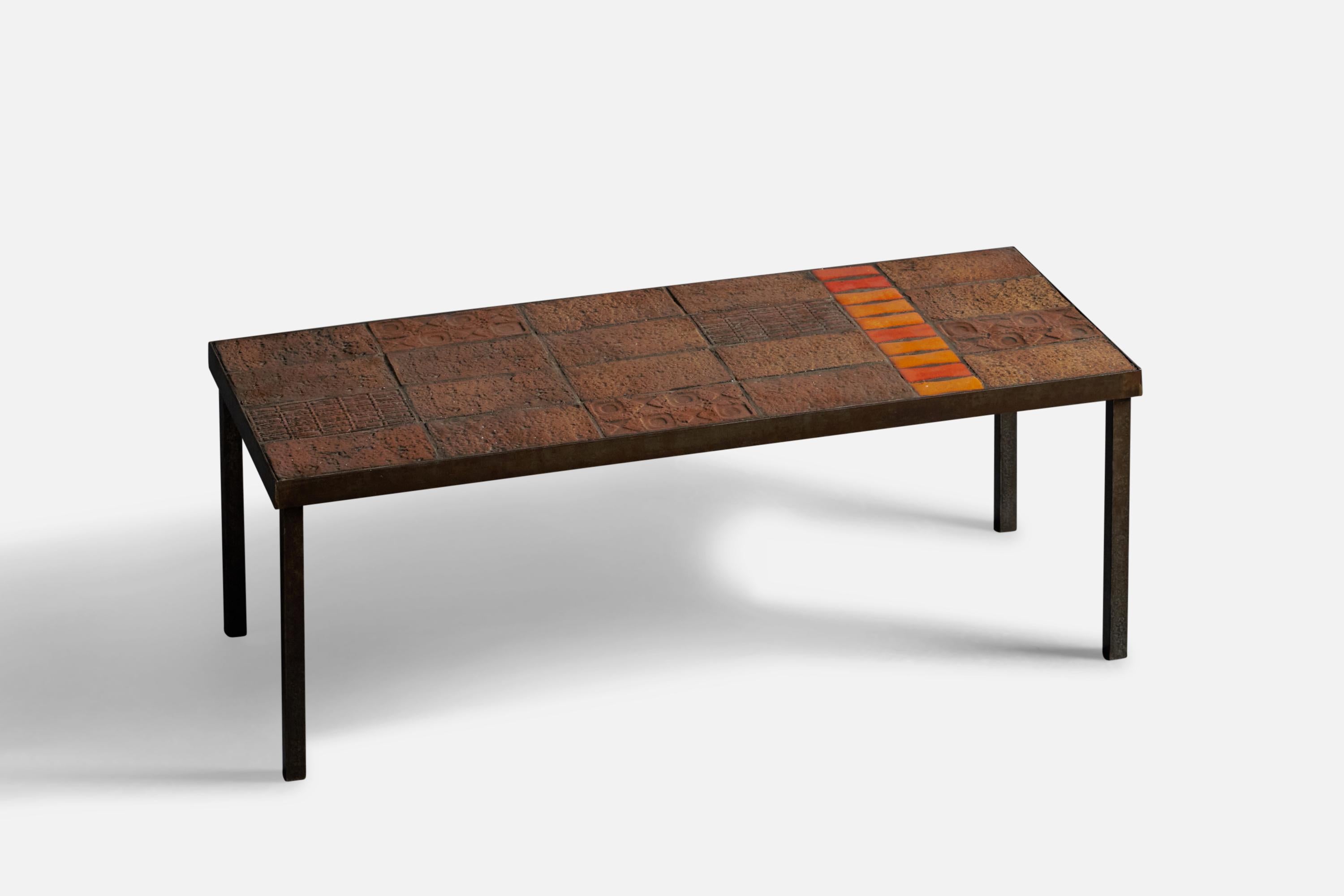A brown and orange-glazed ceramic and iron coffee or cocktail table, designed and produced by Vallauris, France, c. 1960s.