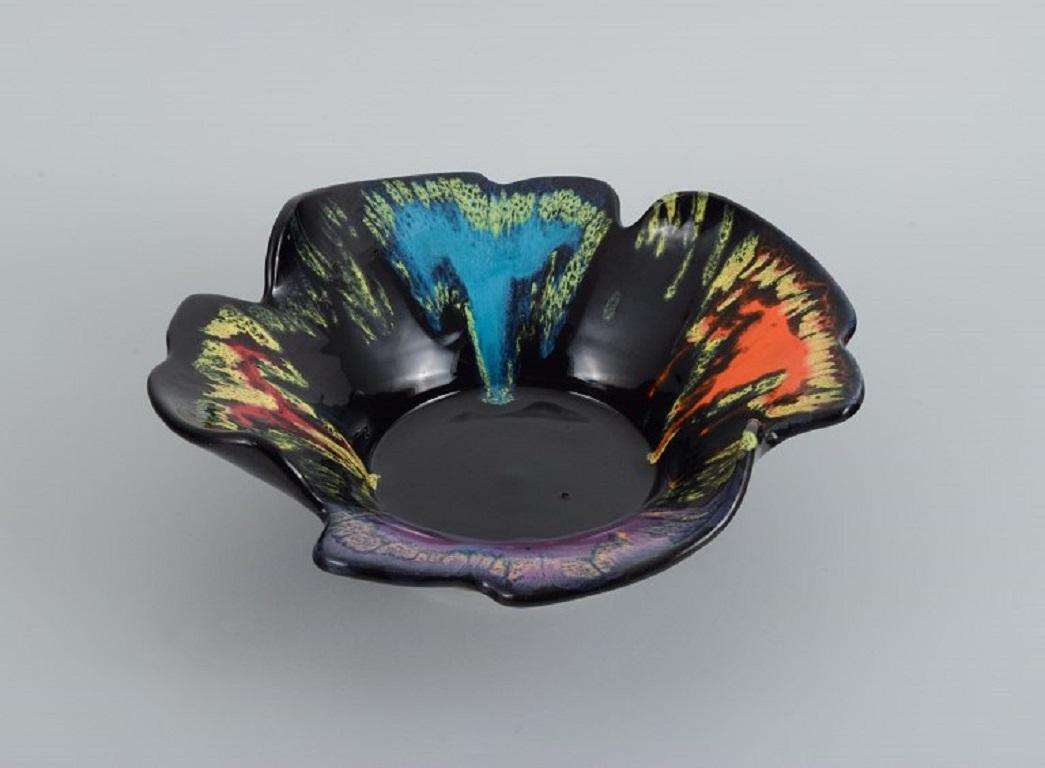 Vallauris, France, ceramic bowl in brightly colored glazes on a black base.
1960 / 70s.
Marked.
In excellent condition.
Insignificant small chip on the lower edge.
Measuring: D 30.5 x H 8.5 cm.