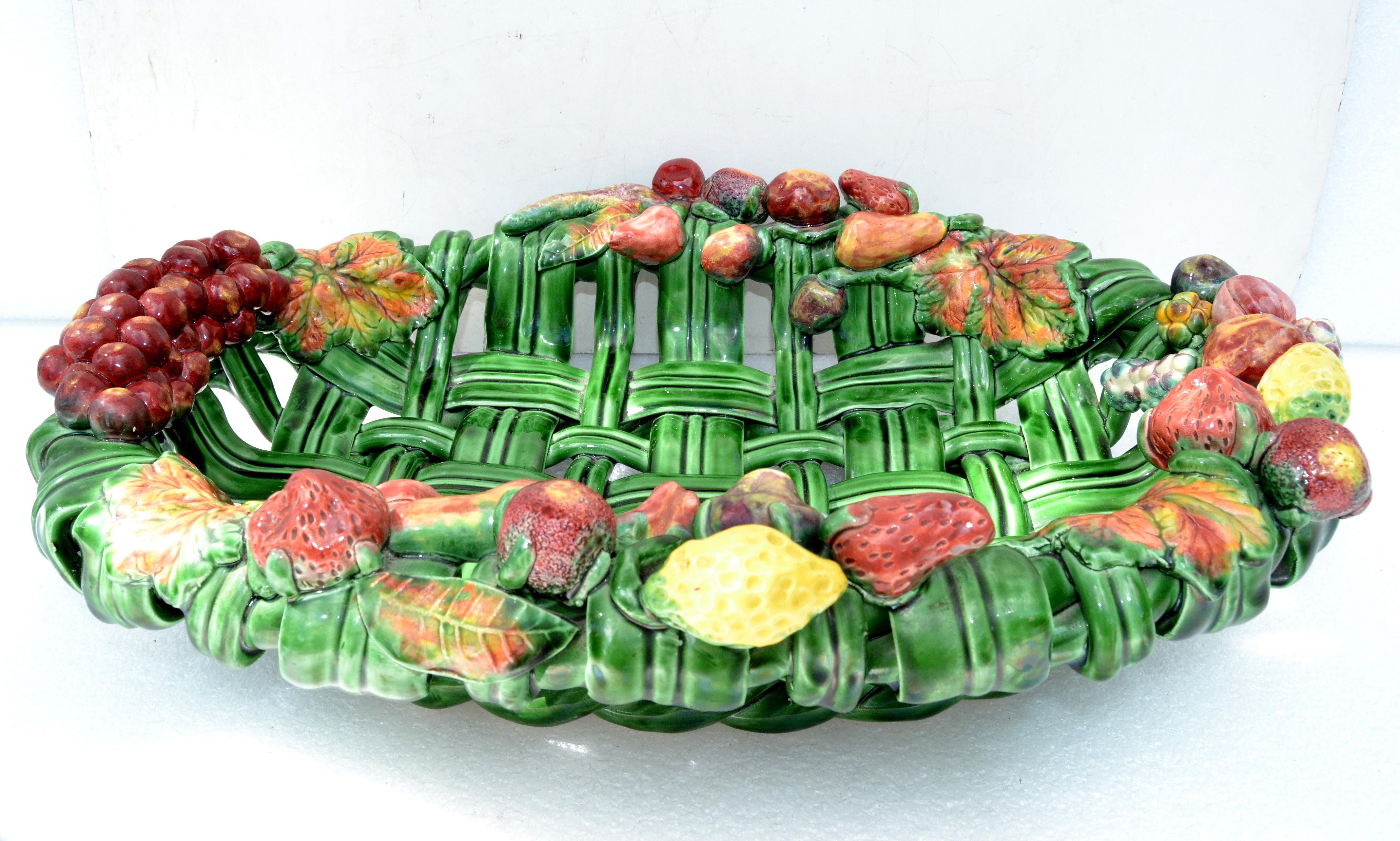 Large oval Mid-Century Modern woven ceramic, Pottery in Emerald Green from Vallauris, small village near the French Riviera.
Depicting a variety of Fruits, like strawberry in different colors.
Marked underneath; Made In France, HENY. 
Great for