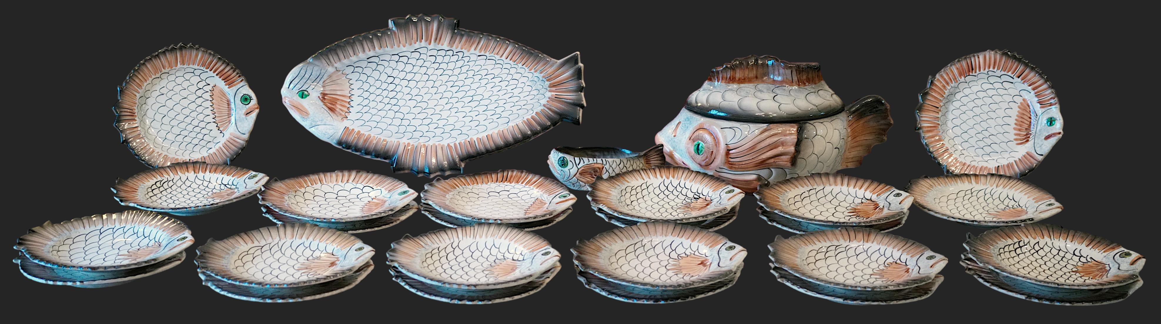 French Mid-century ceramic fish dinner set by VALLAURIS, France, 1970s. 1 tureen, 1 sauce boat, 12 soup plates and 12 dinner plates. Tureen : L43xH22.5xP25.5 cm - W16.9xH8.9xD10 in. Platter : L55.5xH3xP31 cm - W21.85xH1.2xD12.2 in. Sauce boat :
