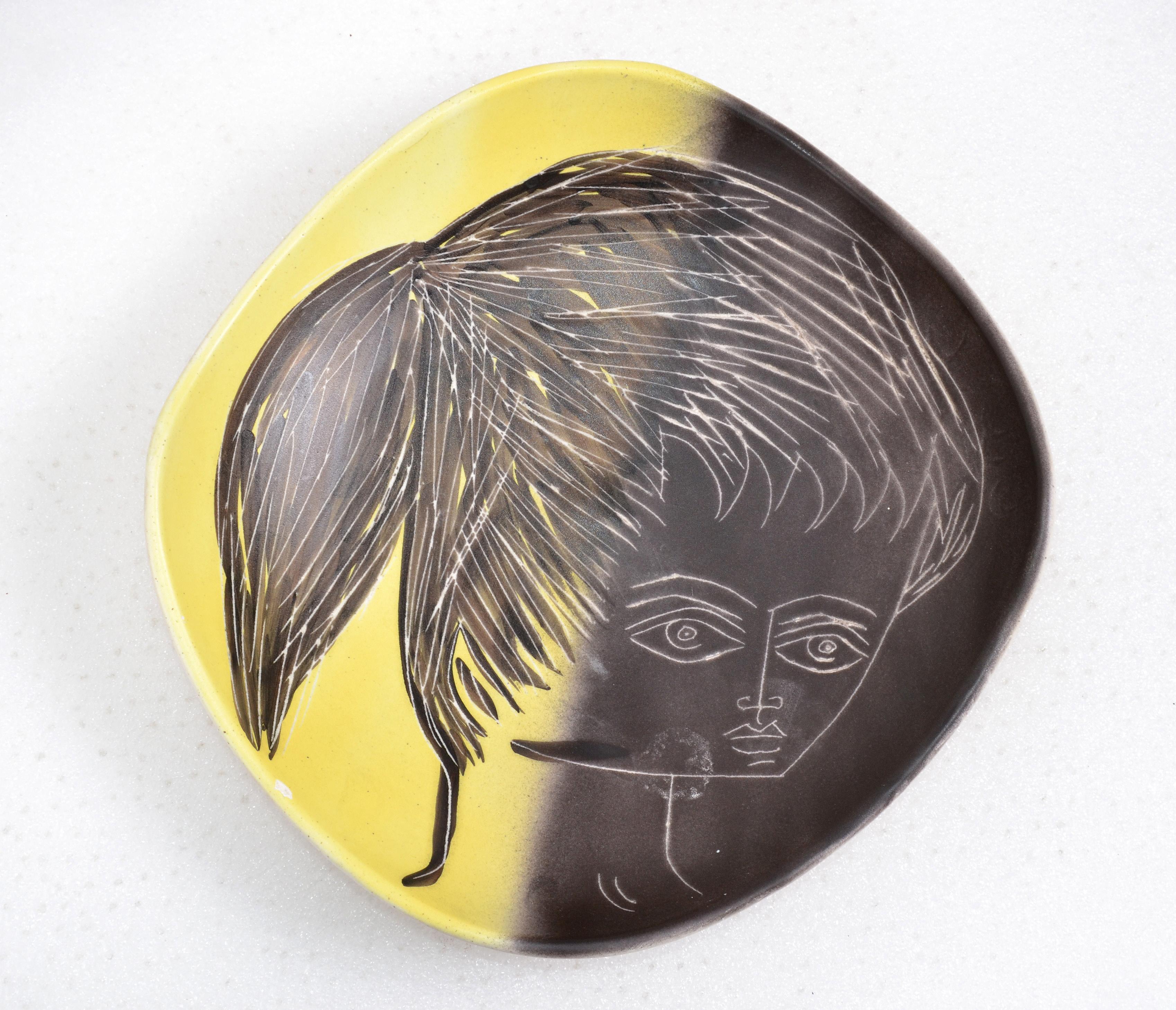 1955 Mid-Century Modern handcrafted ceramic centerpiece, plate designed by Artist M. Barbier depicting a face, from Vallauris, France.
Superb color contrast in yellow, black and beige.
Signed by artist and marked at the base.
  