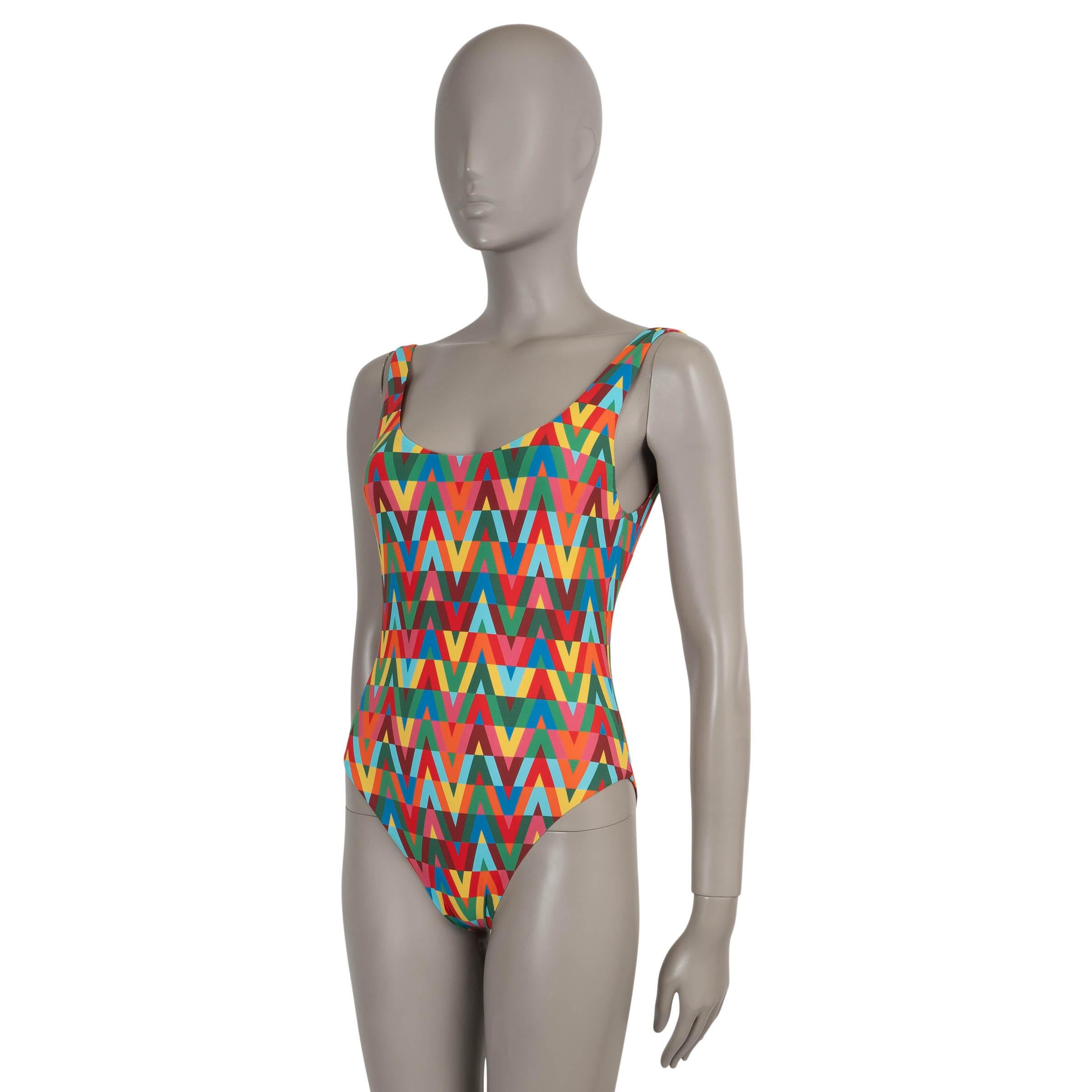 This 100% authentic Valentino swimsuit is crafted in a multicolor polyamide (72%) and elastane (28%) blend, showcasing the bold V Optical Archive 1973 print—a vibrant nod to the house’s iconic graphic heritage. Designed with a flattering scoop
