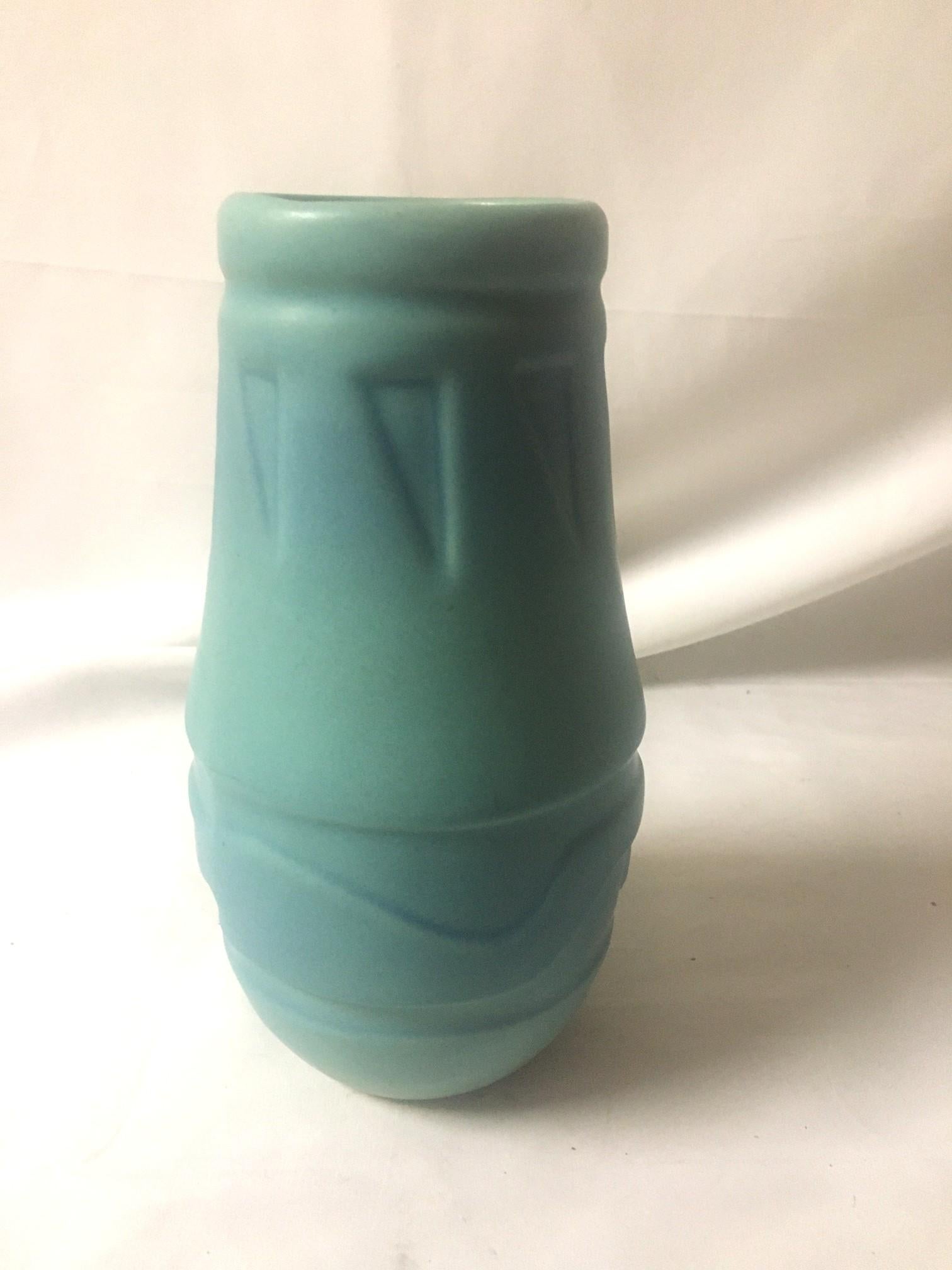 Classic Van Briggle vase circa 1980's or thereabouts. It' has a chic presence with a  dreamy glaze with a lovely variation in coloring from dusty cobalt to teal turquoise. The surface has indentations that are unique and southwestern in style. 
Top