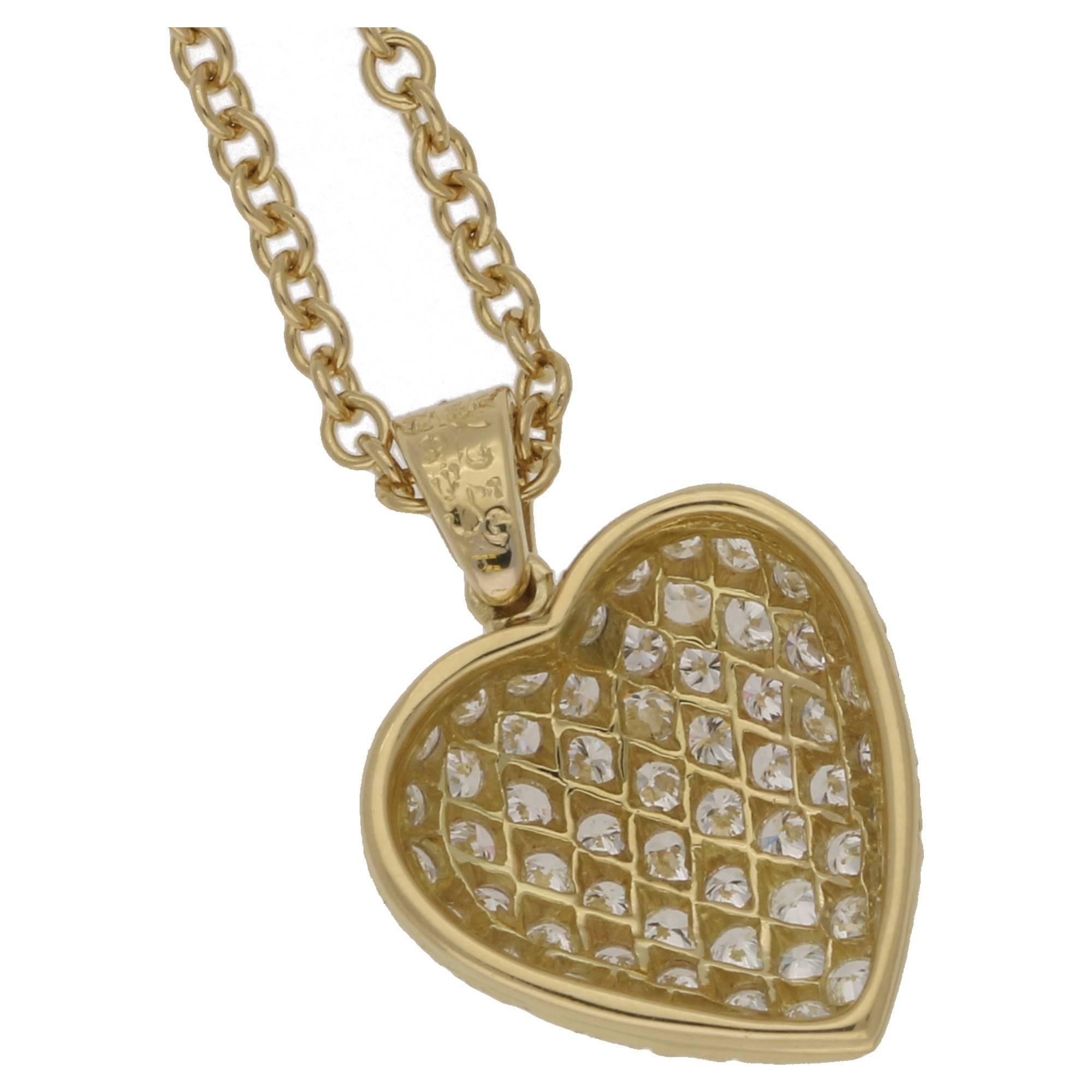 A gorgeous Van Cleef & Arpels diamond heart pendant in 18ct yellow gold on an 18 inch trace chain. The heart features 58 round brilliant cut diamonds pavé set to an articulated bail set with three diamonds. Total diamond weight is estimated as