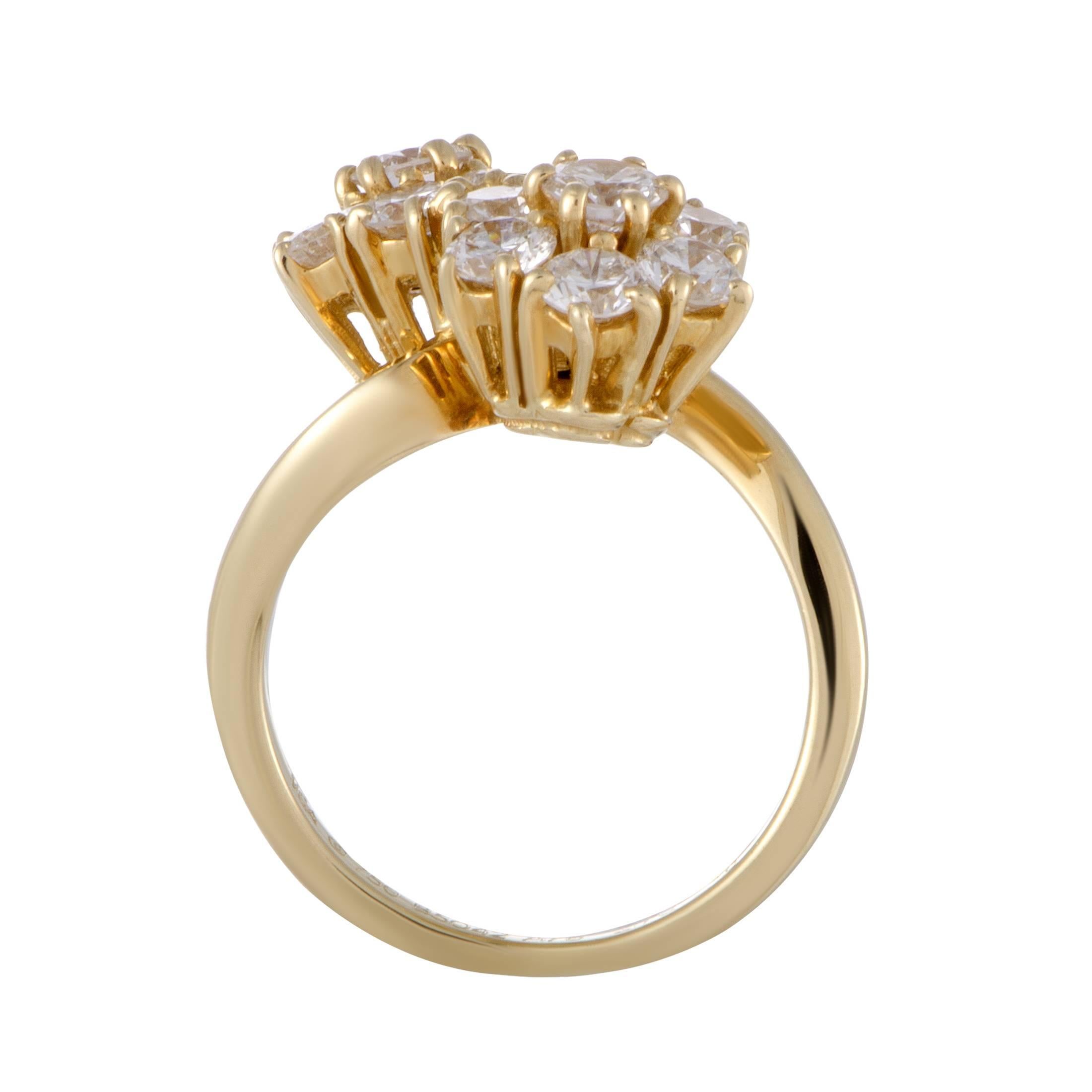 An epitome of graceful elegance, this gorgeously feminine ring is designed by Van Cleef & Arpels and presented in radiant 18K yellow gold. The ring is splendidly decorated with colorless (grade F) diamonds of VVS clarity that weigh 1.70 carats in