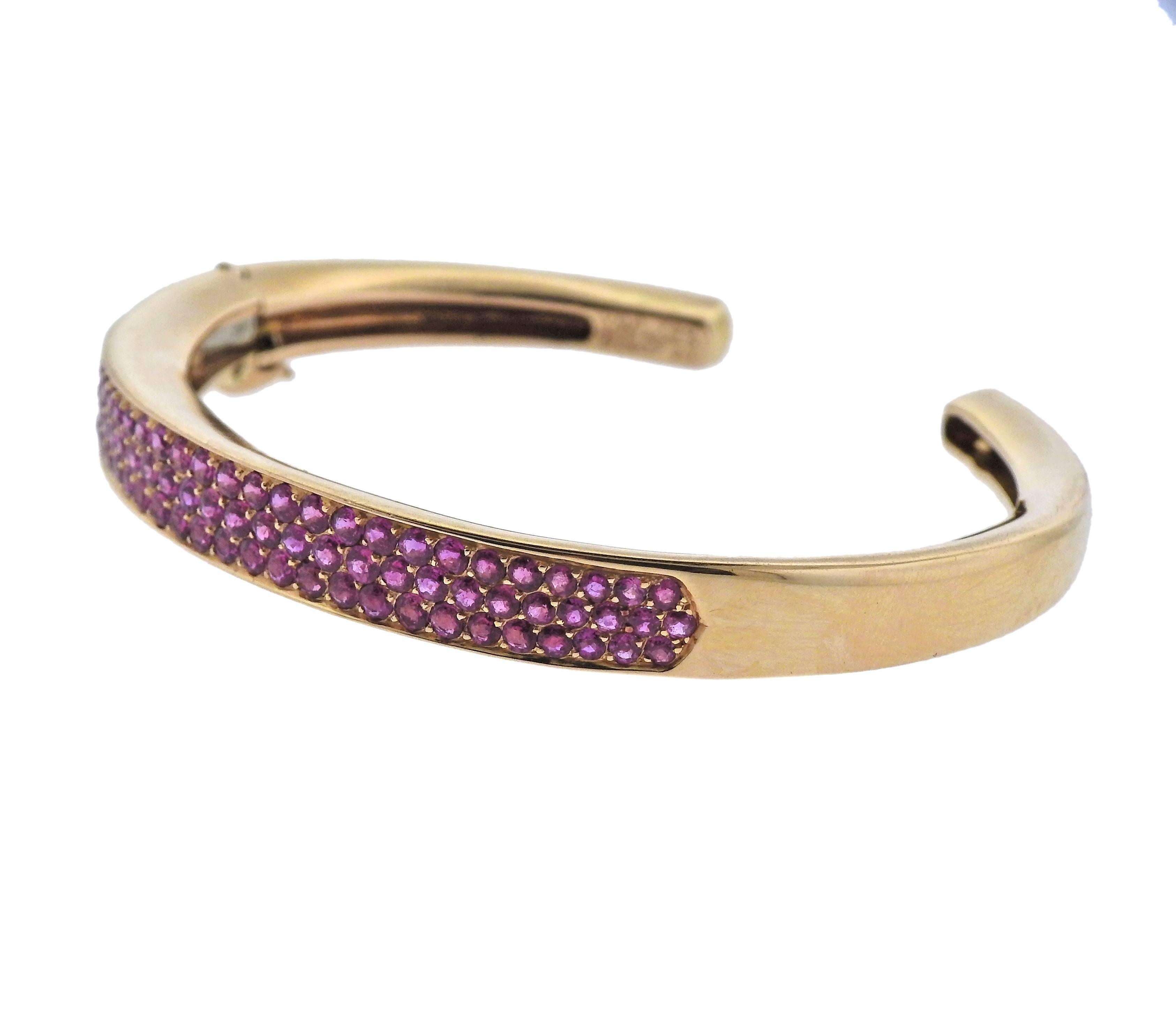 Vintage 18k gold cuff bracelet by Van Cleef & Arpels, set with pink sapphire gemstones.  Bracelet will fit approx. 7