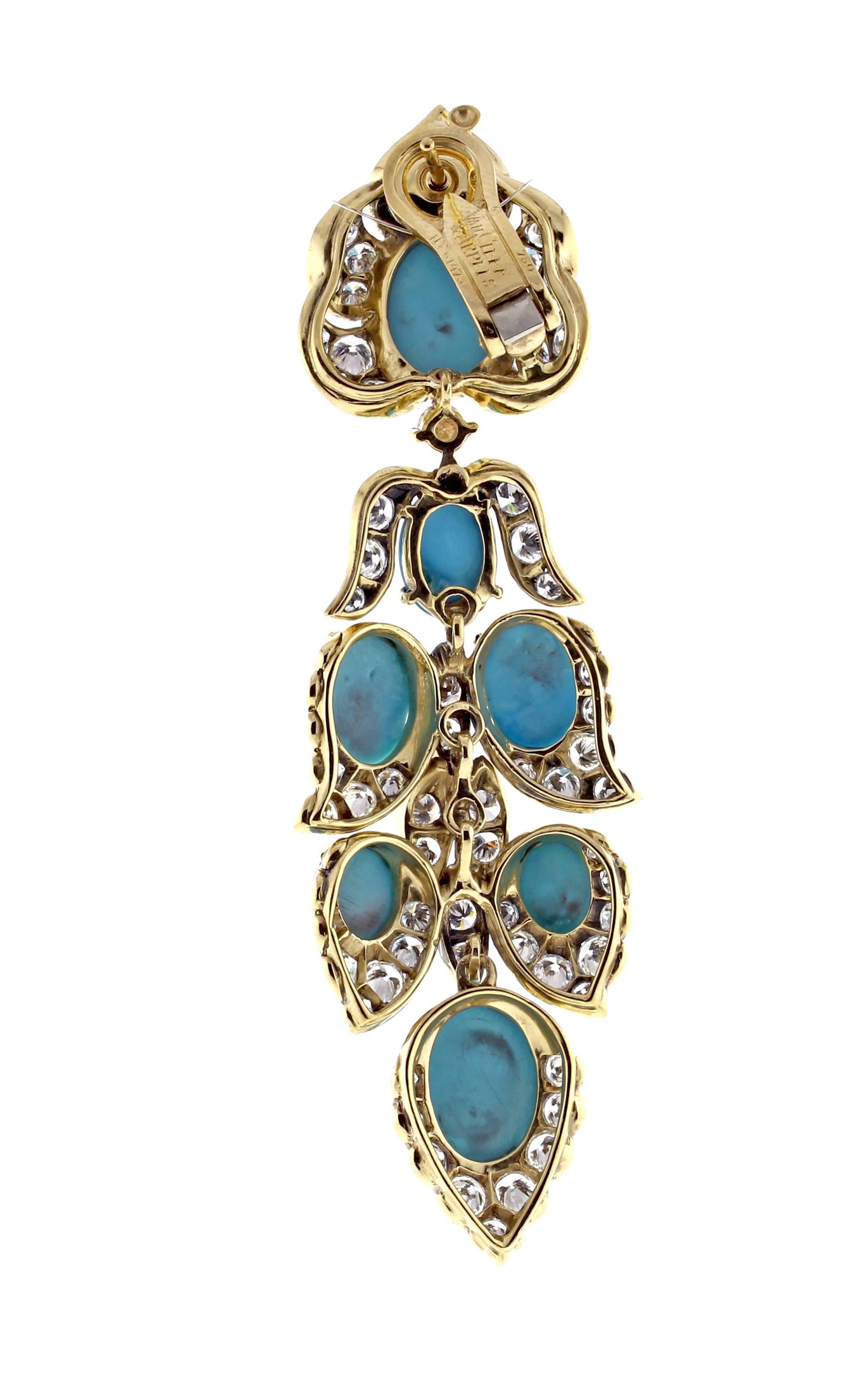 From Van Cleef & Arpels, a magnificent pair of turquoise and diamond drop earrings. The earrings are 3 ¾ inches long and 7/8 inch wide. The stylized foliate designs are set with cabochon turquoise and brilliant cut diamonds. The 160 diamonds weigh