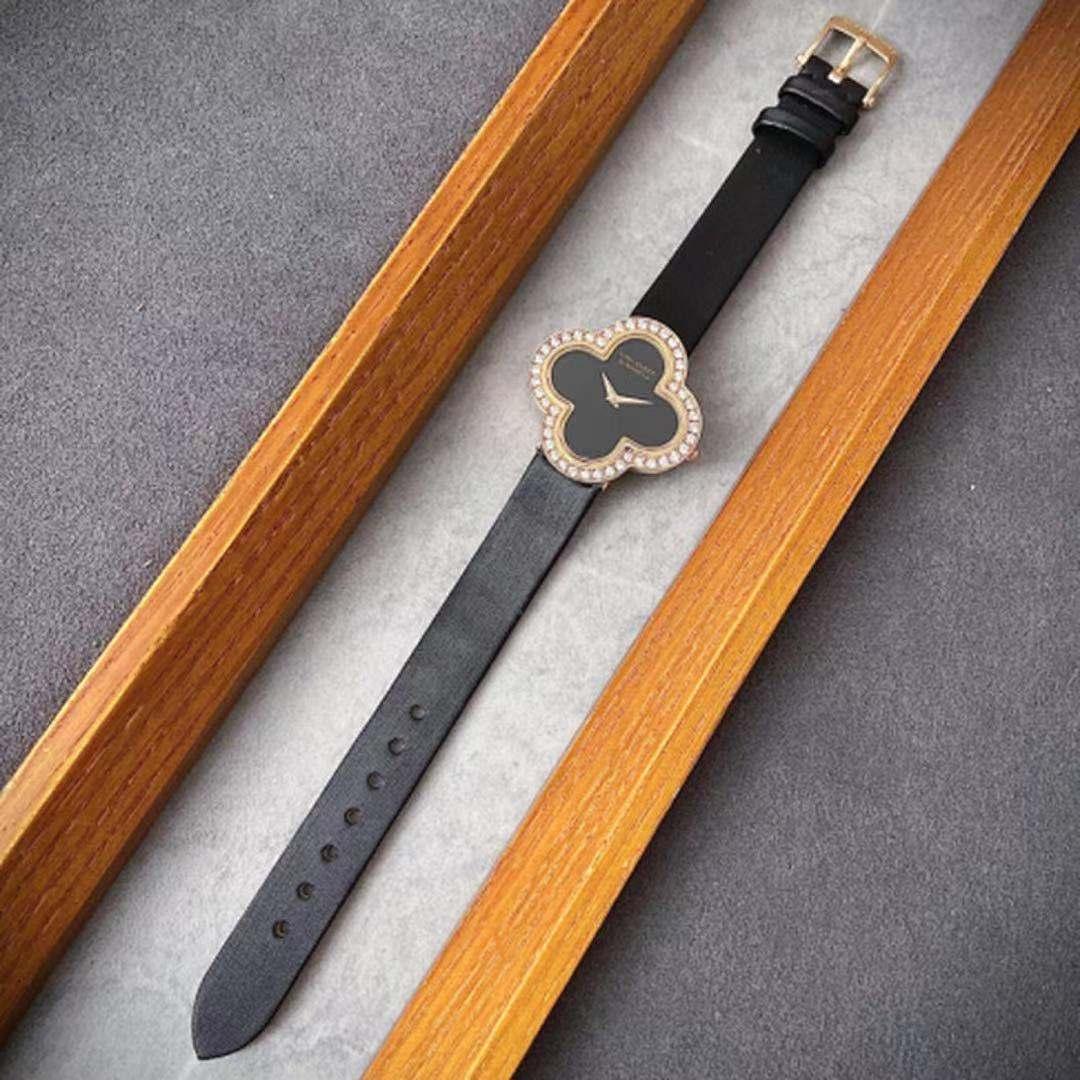 Classic Van Cleef & Arpels 'Alhambra' watch. Centering on the classic clover motif crafted in 18K yellow gold. A chic black onyx dial features gold-toned sword-shaped hands and signed Van Cleef & Arpels Paris. A black satin bracelet is finished with