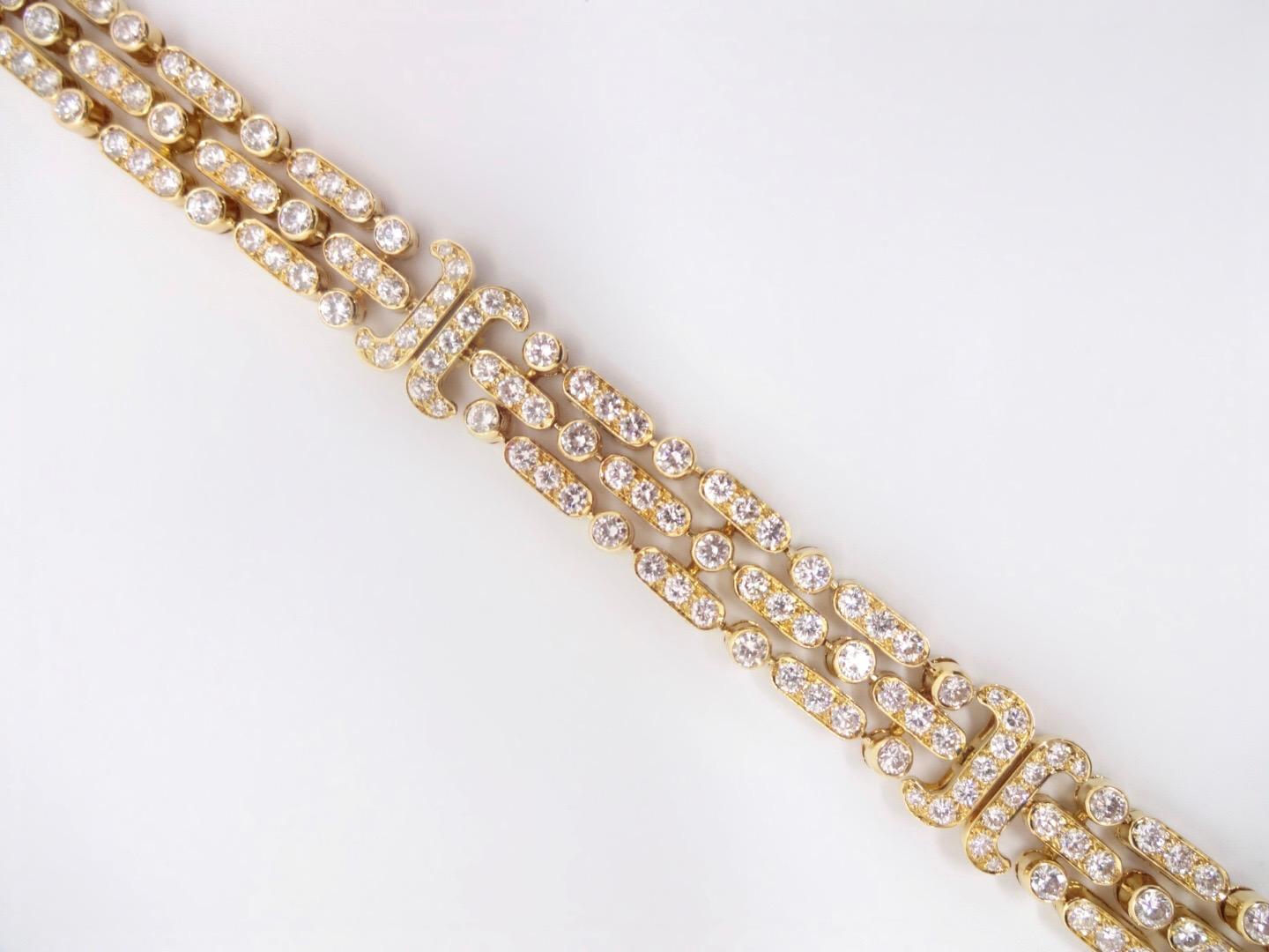 This timeless 18K yellow gold and diamond flexible bracelet by Van Cleef & Arpels has almost 9 carats of round brilliant diamonds laid out in a three row design, bracketed into three distinct sections.  It looks beautiful alone or stacked with other
