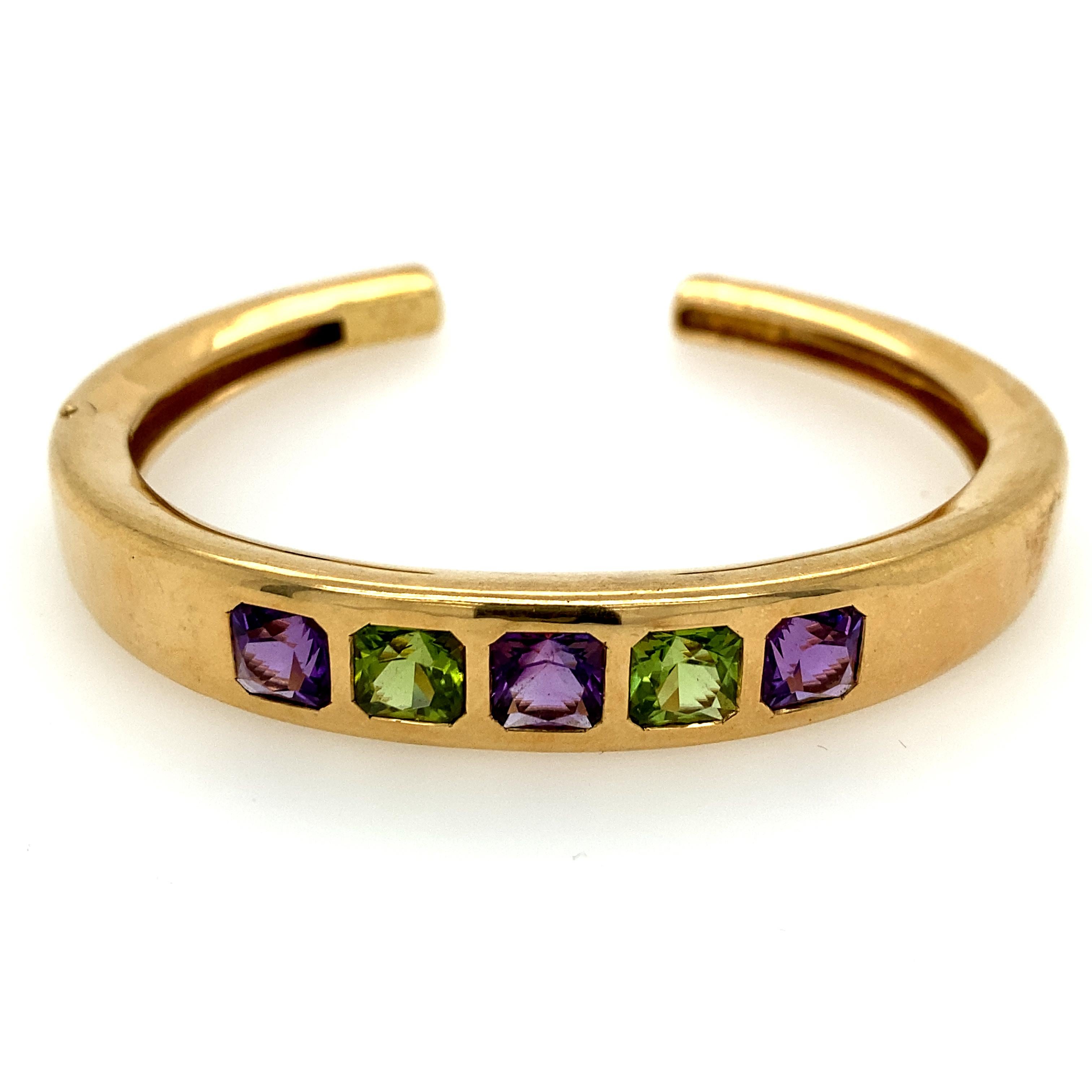 Van Cleef and Arpels 18k Yellow Gold Bracelet with Gem Stones. There are three square-cut amethysts and two square-cut peridots. The bracelet is signed VCA 750 B2612D3. The bangle has a hinged opening and a safety clip.