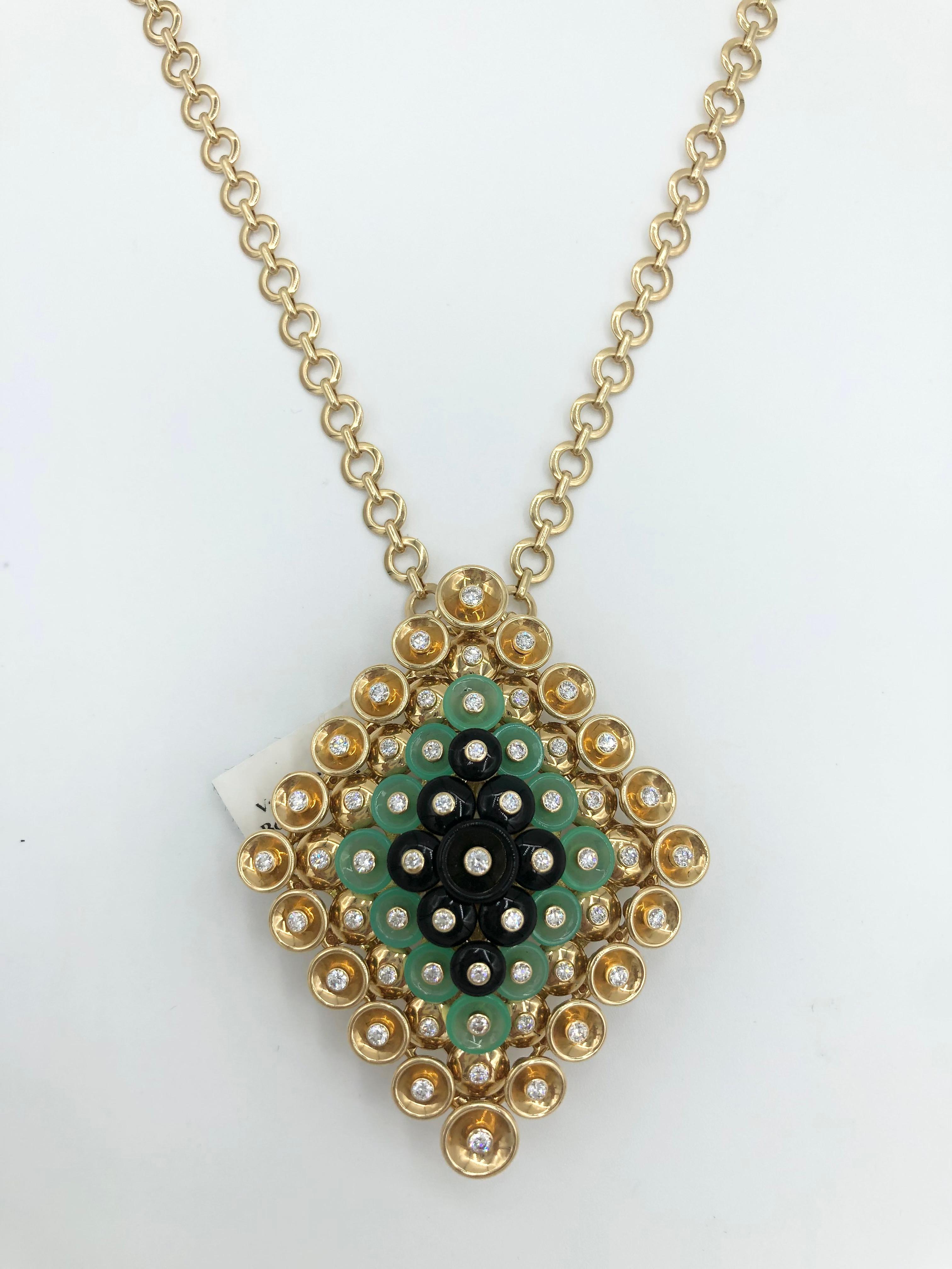 The Van Cleef & Arpels Bouton d'Or Pendant with Detachable Clip 

18K yellow gold, Chrysoprase, Onyx, and round diamonds

57 round diamonds, totaling 1.46 carats, meticulously set in 18K yellow gold. 

Features a detachable clip that allows you to