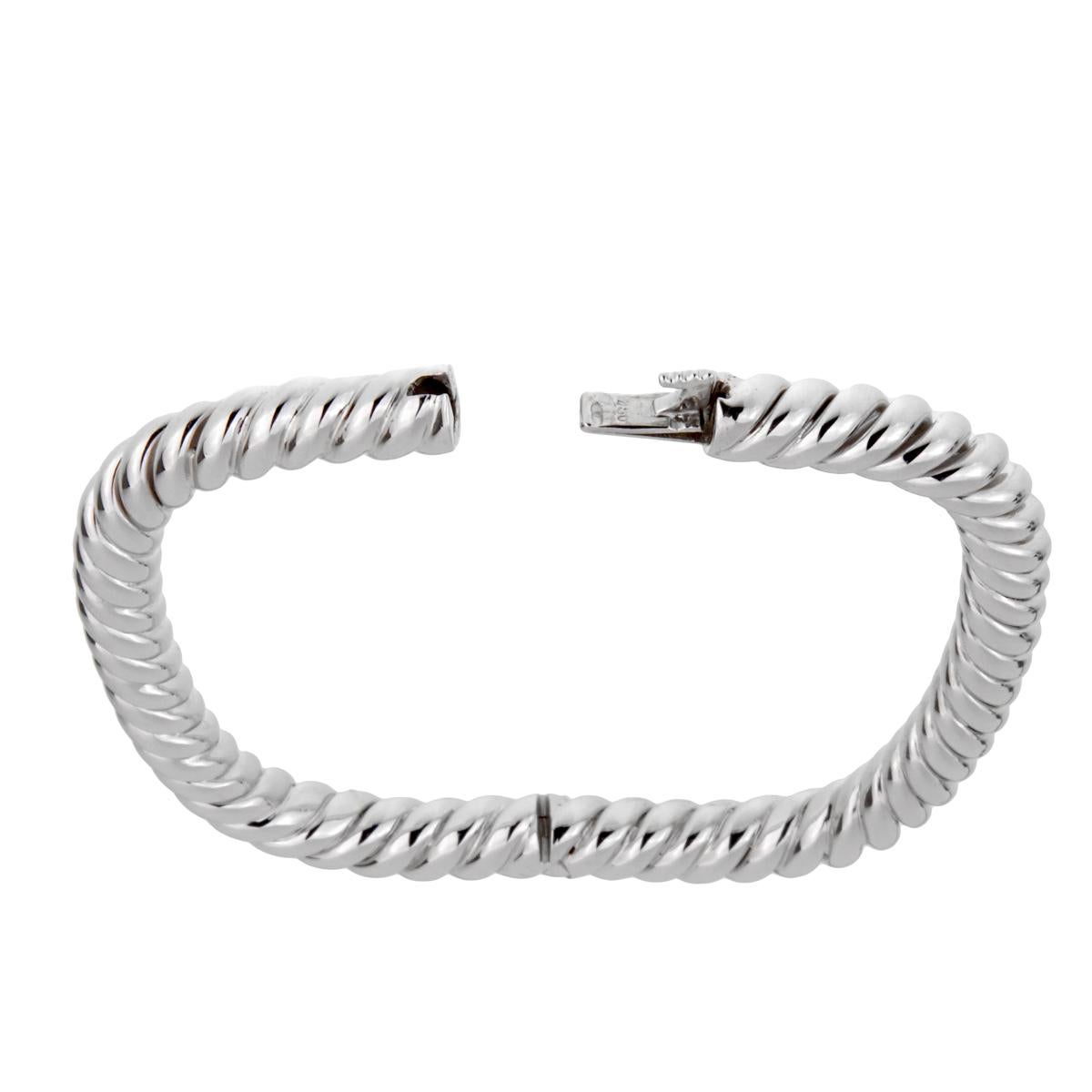 A fabulous Van Cleef & Arpels bangle bracelet circa 1990's featuring a braided design in glimmering 18k white gold. The bracelet was just cleaned and serviced and is accompanied with the documents from Van Cleef & Arpels.

Wrist Size: Upto 7 1/2