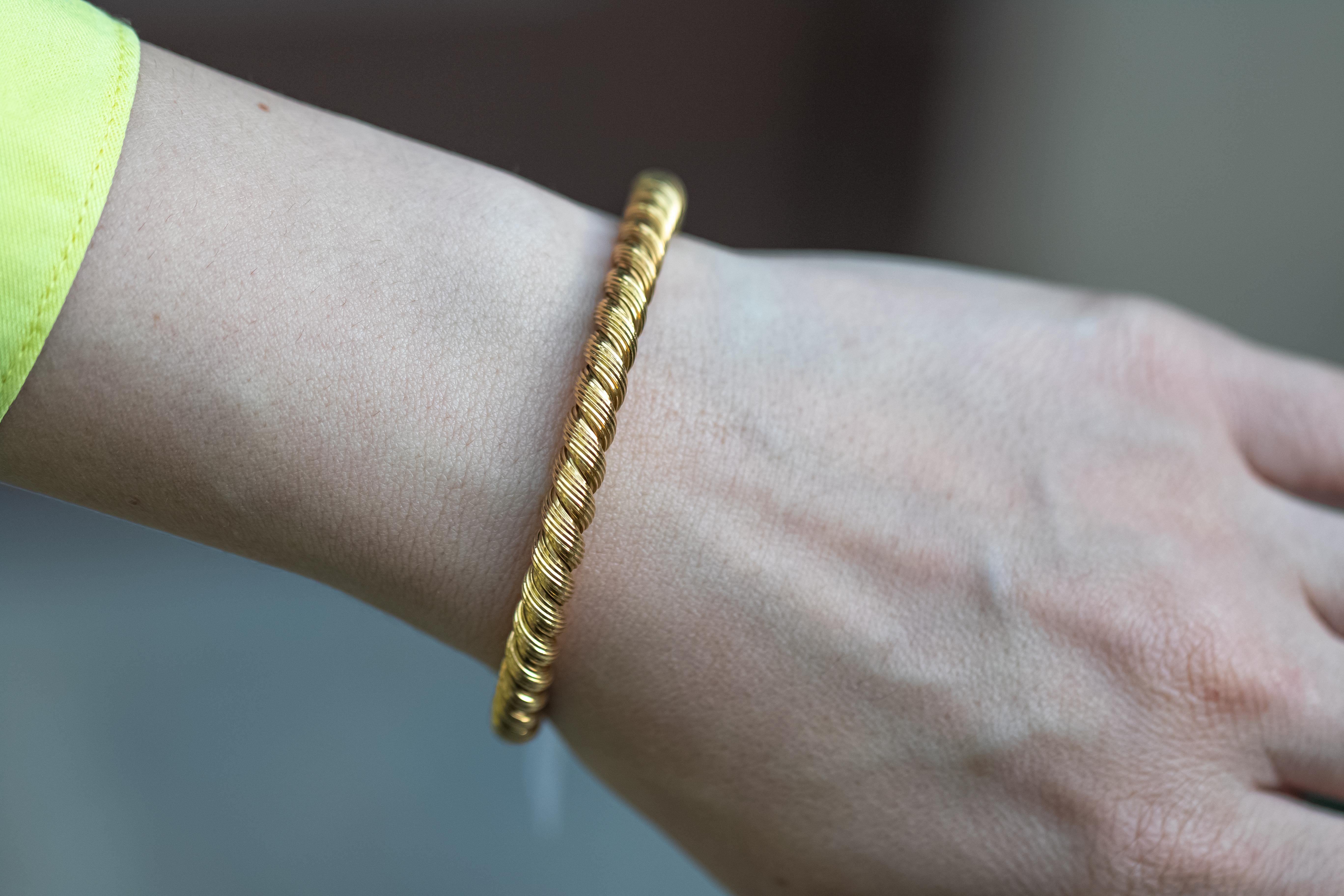 A fabulous Van Cleef & Arpels hand made bangle bracelet featuring a braided design in glimmering 18k yellow gold.
