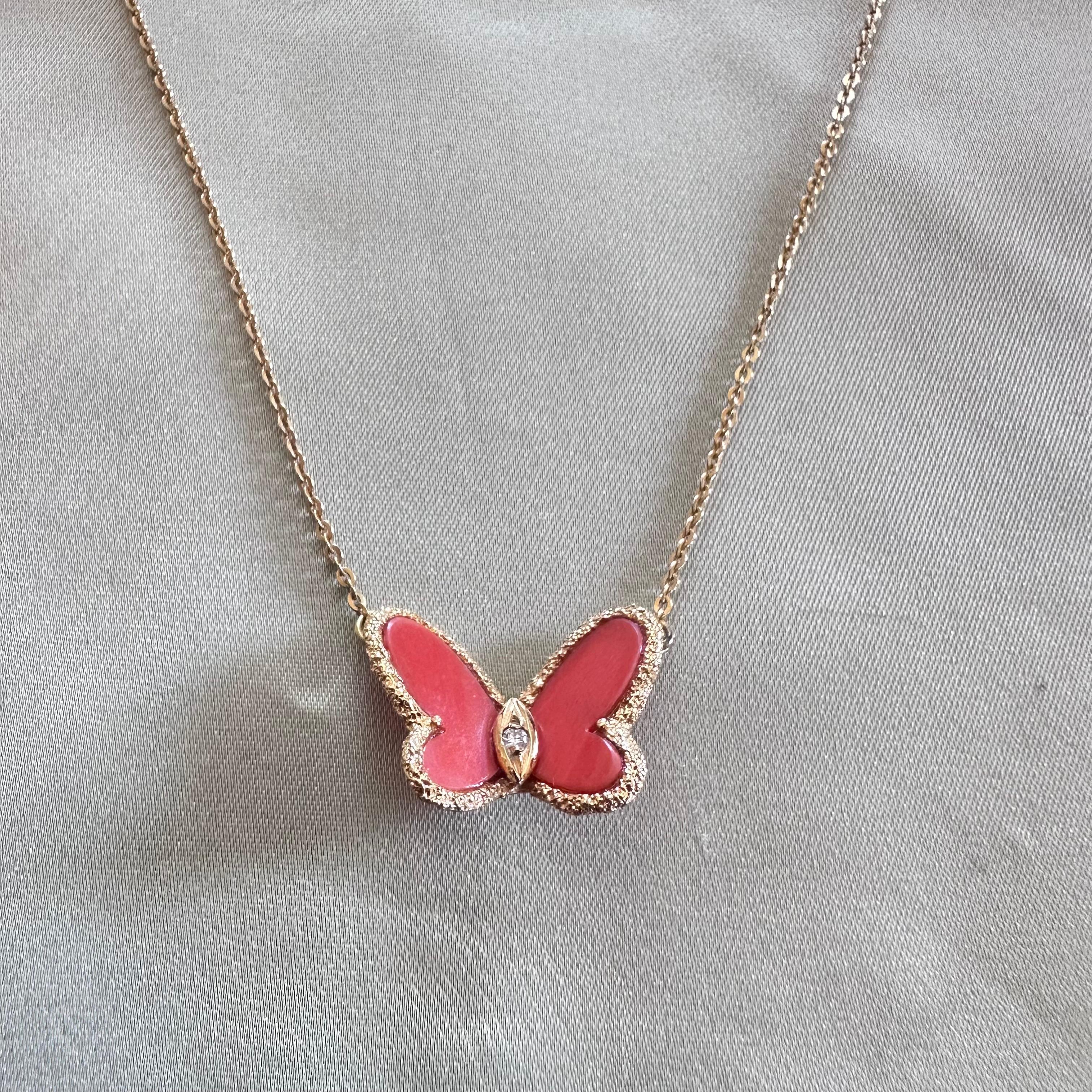 Van Cleef & Arpels Coral and Diamond Butterfly Pendant Necklace.   Crafted in 18-karat yellow gold, it boasts a captivating butterfly Motif in Coral. Combining Van Cleef & Arpels' timeless elegance with mid-20th-century allure, Featuring 2 Coral