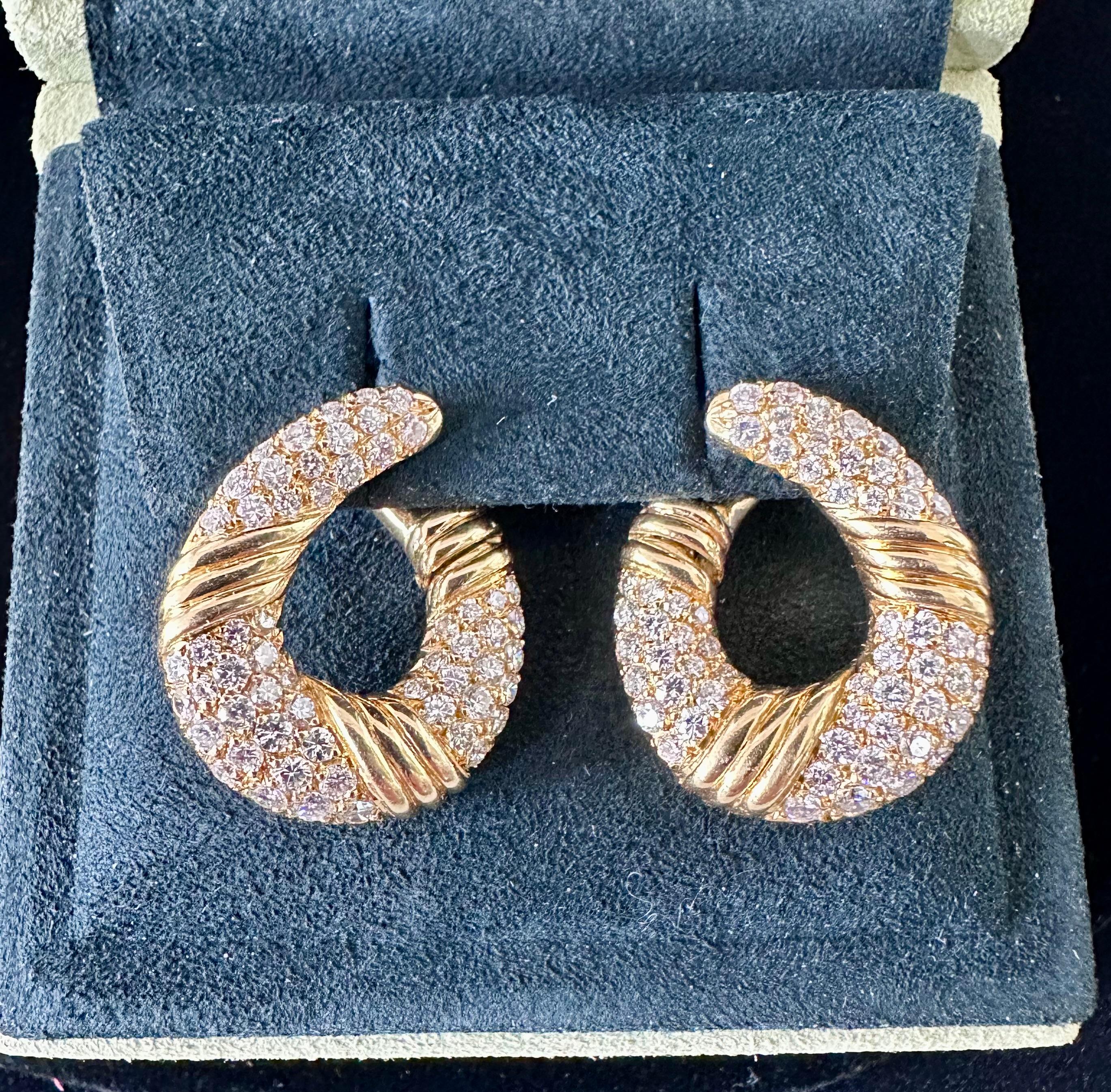 Van Cleef and Arpels Earrings of a Hoop Designed Earrings. Rows of Tapering Pave Set Diamonds Est Weight 2.30 cts. Hinge opening Mechanism signed Van Cleef and Arpels & numbered circa 1990 stamped 750 for 18k Yellow Gold 
Dimension: 25mm X 18mm

