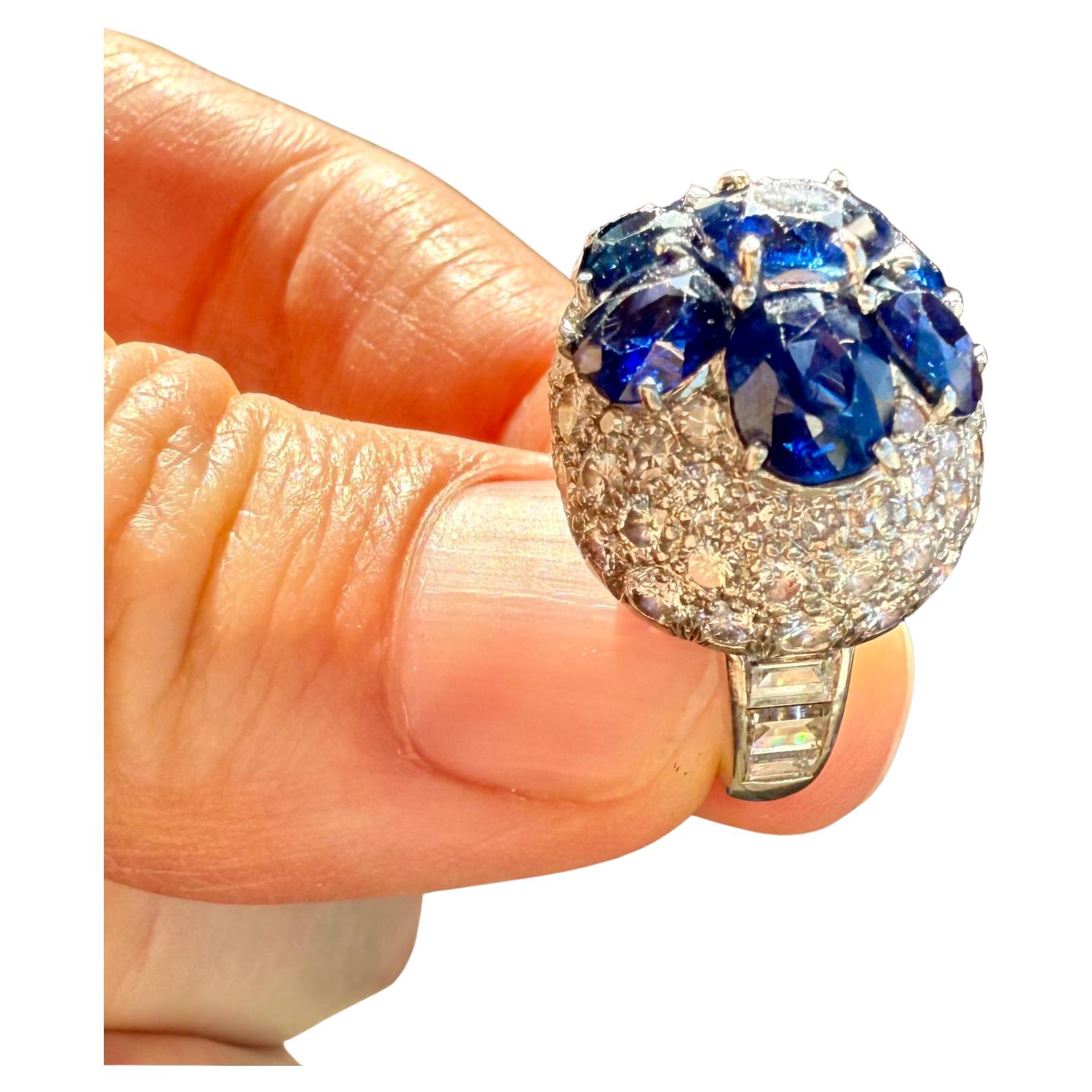 Van Cleef and Arpels
Blue Sapphire Diamond Ring.
8 Oval Shape Blue Sapphires  6 cts 
Numerous Round Diamonds  3.5 cts 
Size 4.5
!8k White Gold and Platinum 
Hallmarks: Van Cleef & Arpels NY and Numbers
