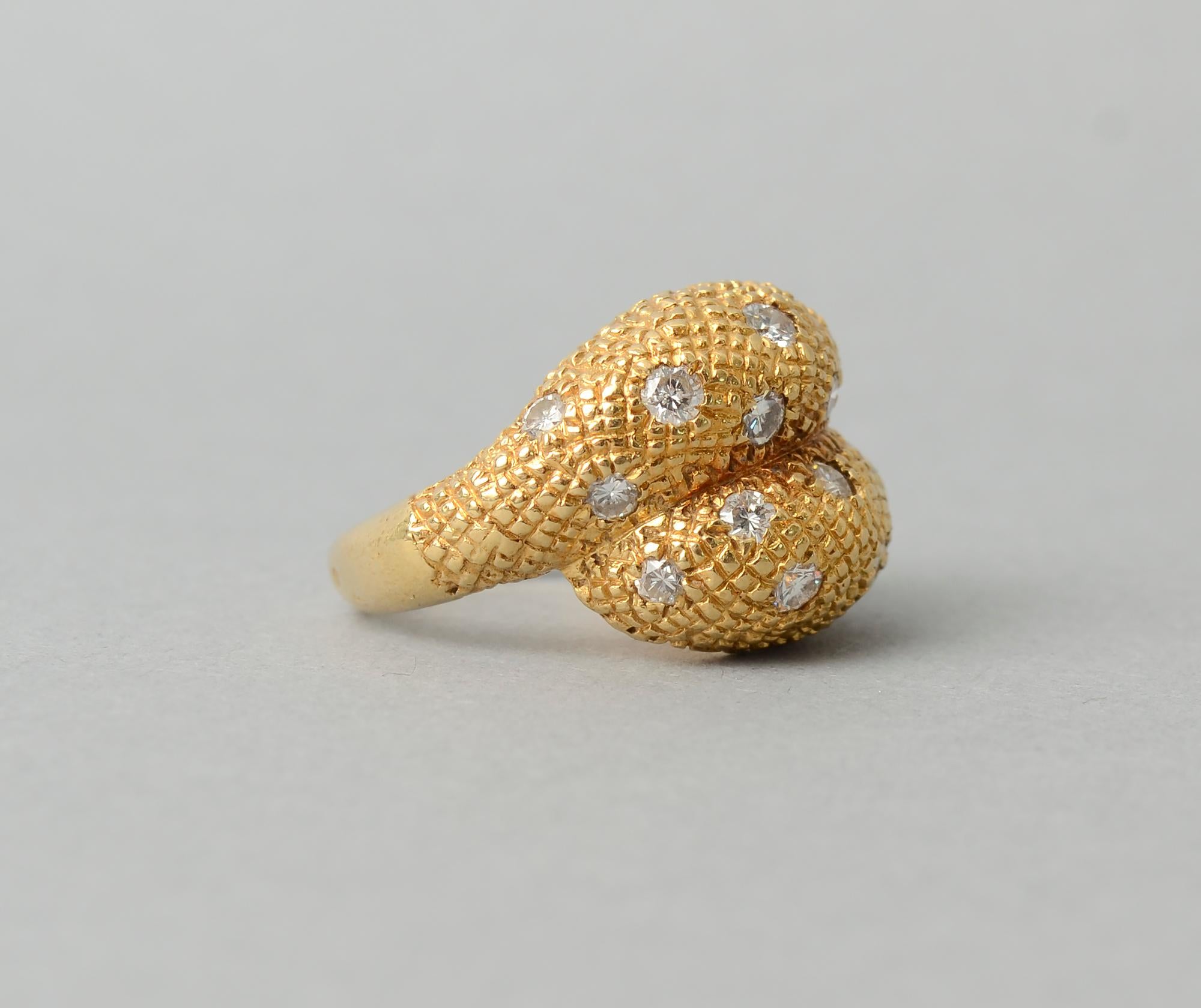 Stylish and elegant 18 karat gold cocktail ring by Van Cleef and Arpels France. The beautifully textured crossover ring has 18 diamonds that weigh a total of approximately 1.8 carats.
The ring is size 5 1/4. It can easily be sized up or down.