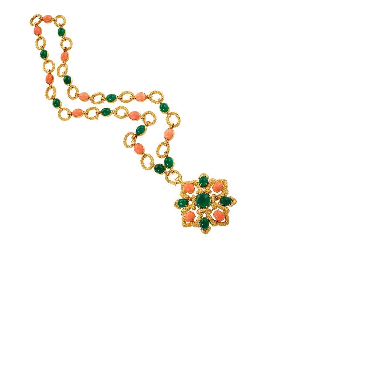 A French gem-set sautoir by Van Cleef and Arpels. The necklace is a textured 18 karat gold link chain with collet-set oval coral cabochons alternating with chrysoprase cabochons.  A detachable pendant/brooch of rosette 