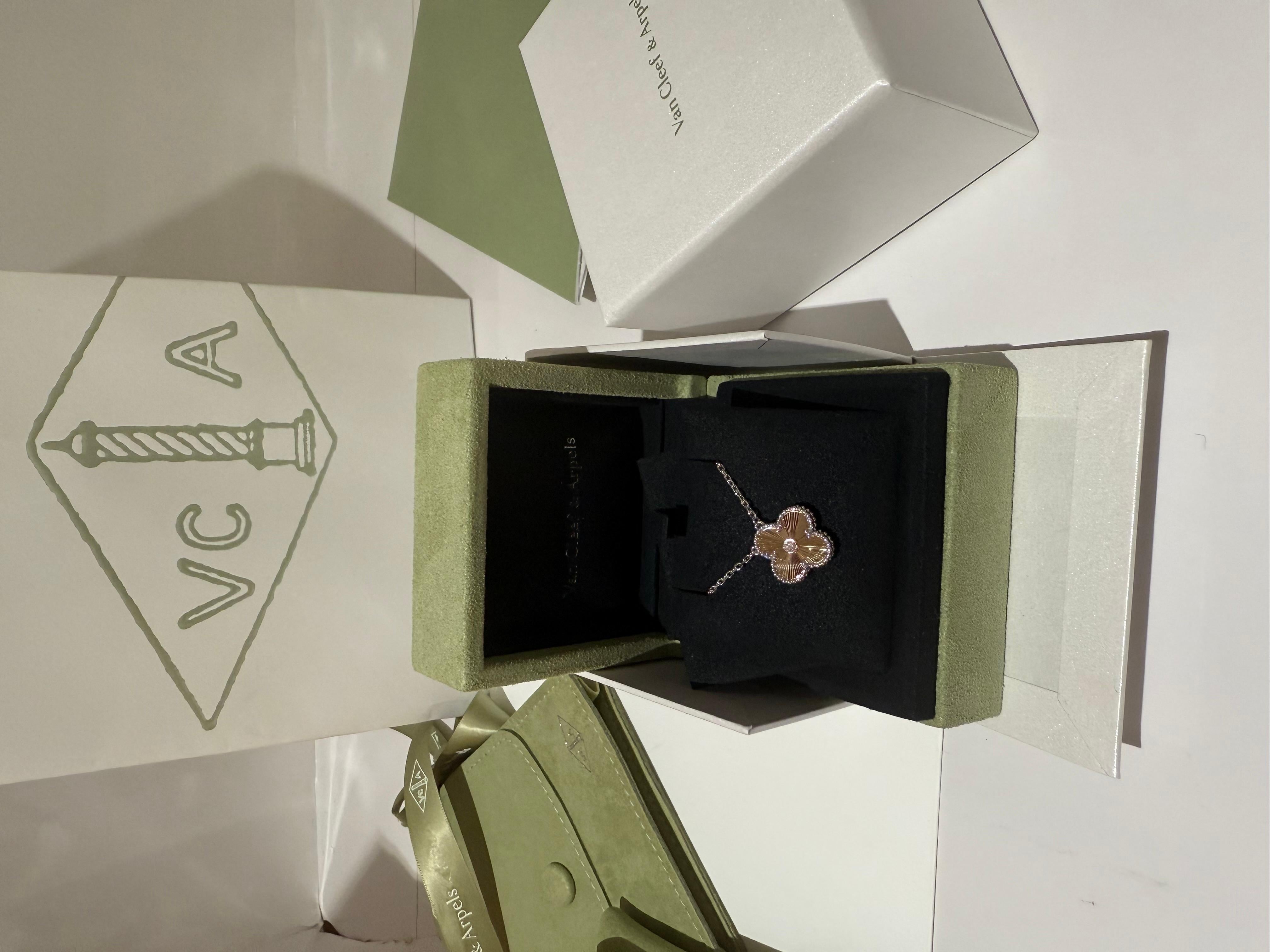 Van Cleef and Arpels new holiday pendant 2024, Vintage Alhambra Pendant in 18K white gold, 18k rose gold Guilloche and a central diamond. Limited release. 