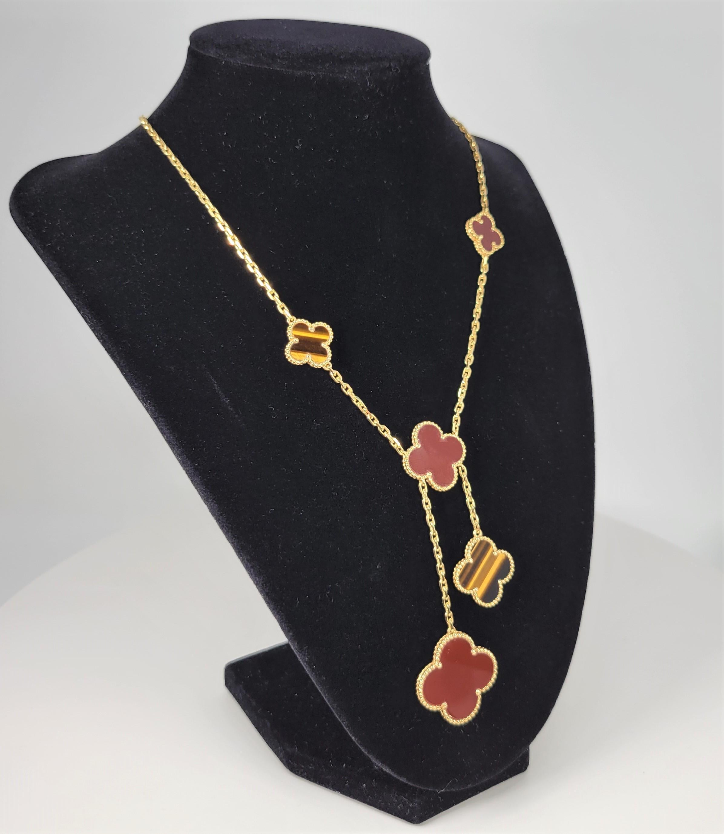 Your chance to own an iconic necklace from famed jewelry house Van Cleef and Arples!  With original box and paperwork, this beautiful tigers eye and carnelian necklace is from the Magic Alhambra line with  6 motifs and is stamped VCA (Van Cleef and