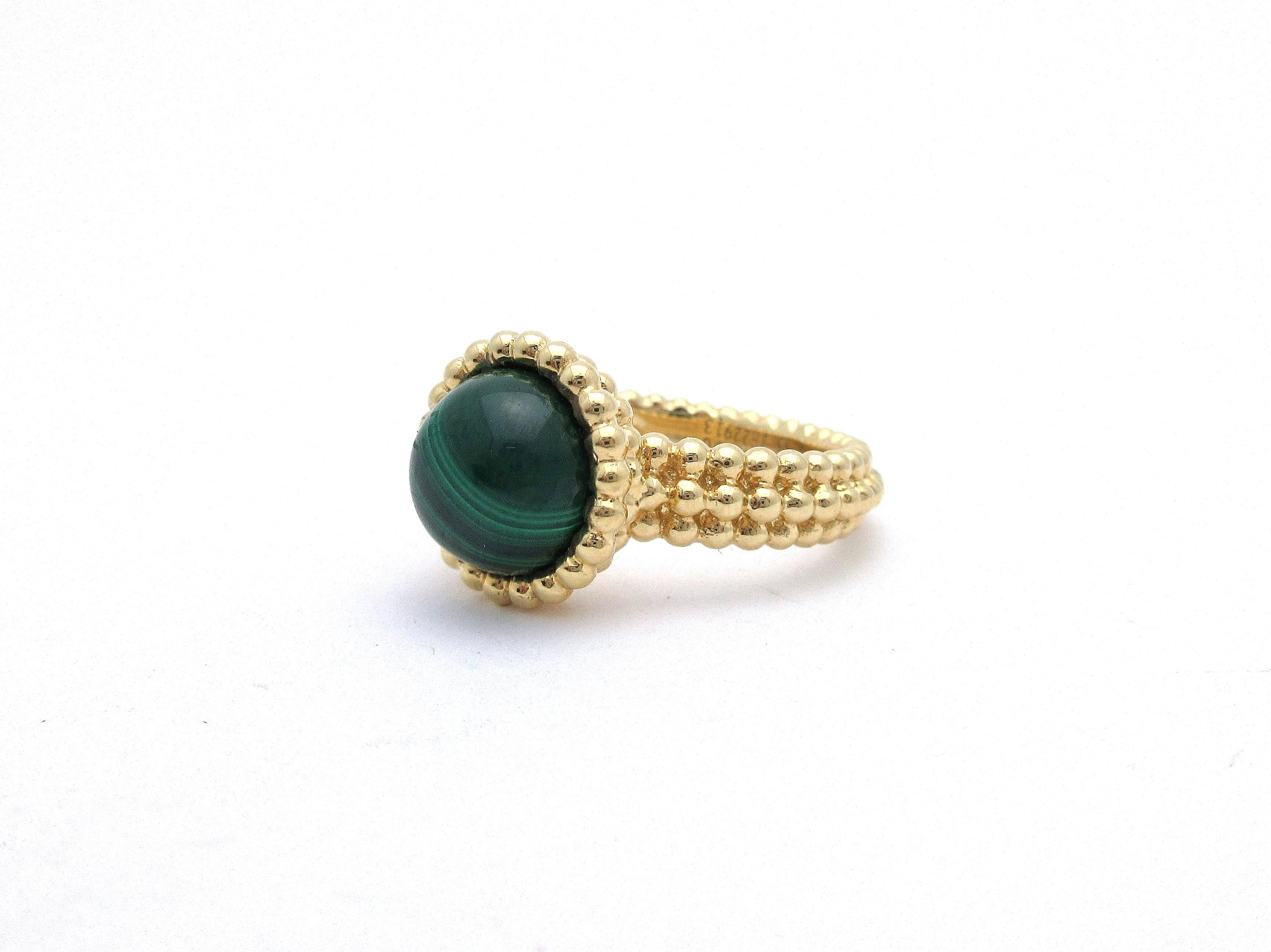 This beautiful ring by Van Cleef and Arpels is from the Perlee Couleurs collection and set with a green malachite cabochon.  Made from 18k yellow gold, the ring features beaded details all the way around.  It is a size 55, and the ring face measures