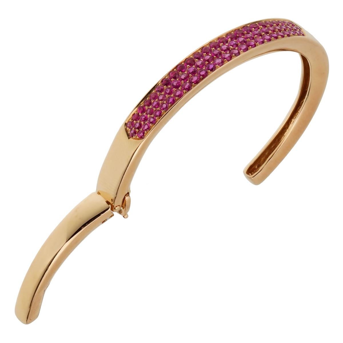 A fabulous Van Cleef & Arpels bracelet circa 1980, this luxurious bracelet features 3 rows of vivid pink sapphires set in shimmering 18k rose gold.