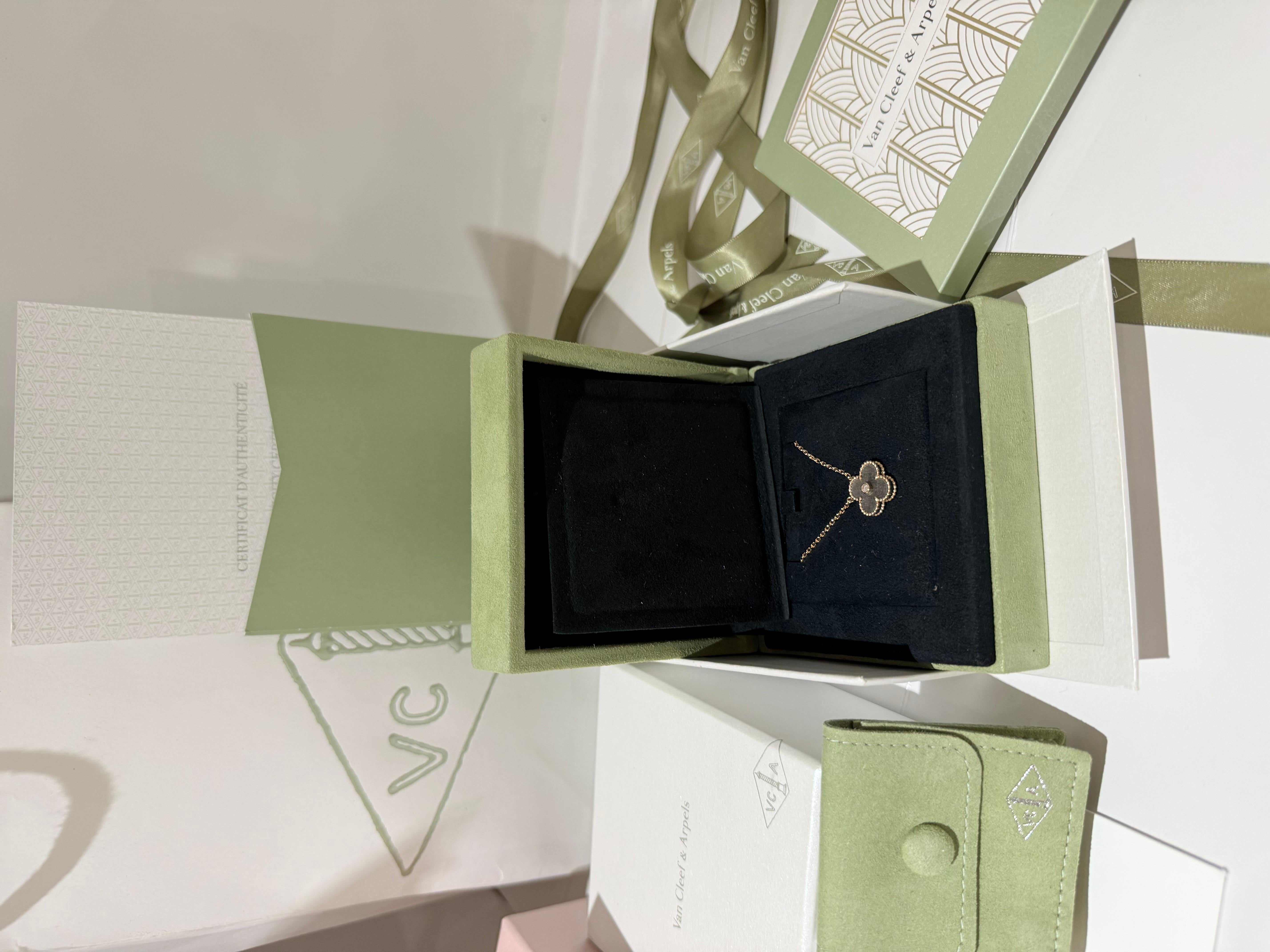 Van Cleef & Arpels Vintage Alhambra holiday pendant 2023 Obsidian and diamond. A limited edition 18k rose gold Silver Obsidian and diamond  from the 2023 Holiday collection. The pendant features a beaded edge 4 leaf clover motif and a single bezel